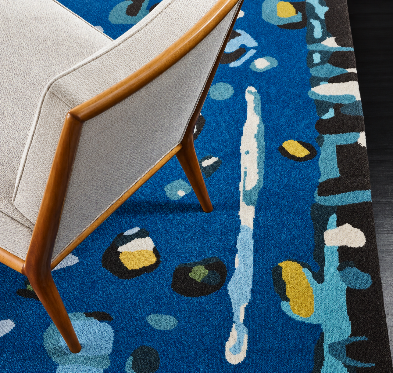 Mid-Century Chair on Abstract Blue Rug.png
