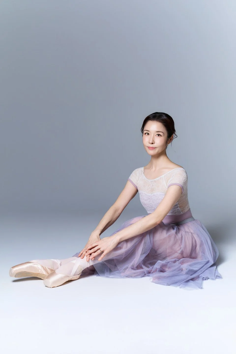 Julie seated in a lavender ballet dress for a studio portrait.