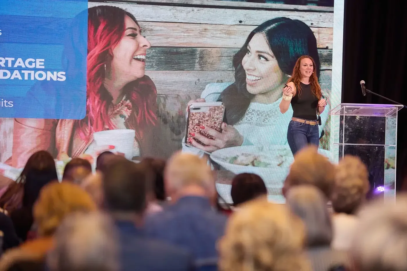 A photo of a woman giving a presentation onstage at a corporate event in Montreal.