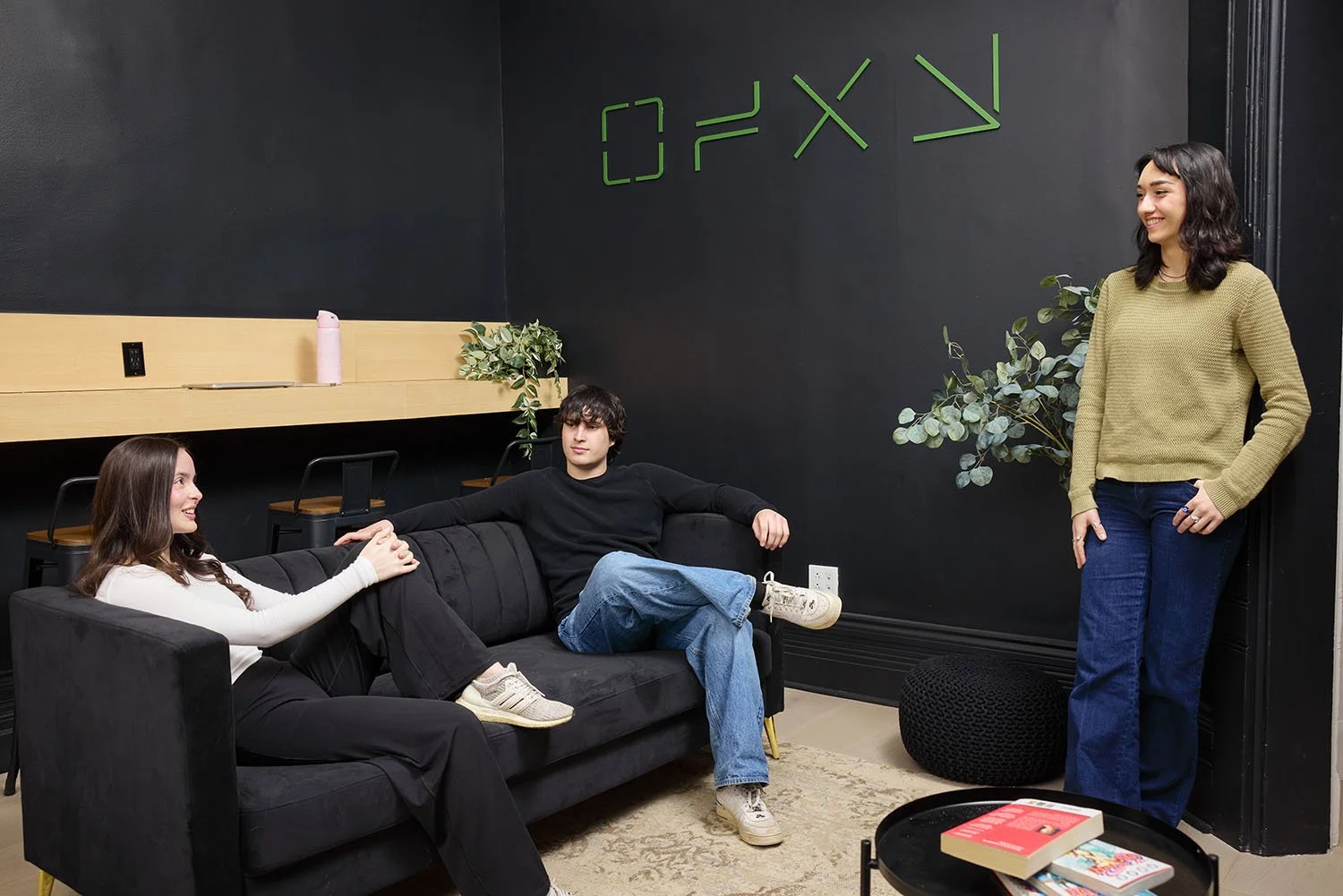 A lifestyle photo of a group of young adults hanging out in the common space of a youth hostel in Montreal.