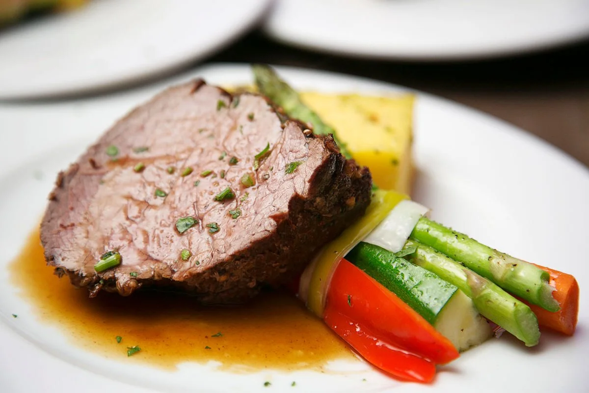A serving of beef and vegetables on a plate.