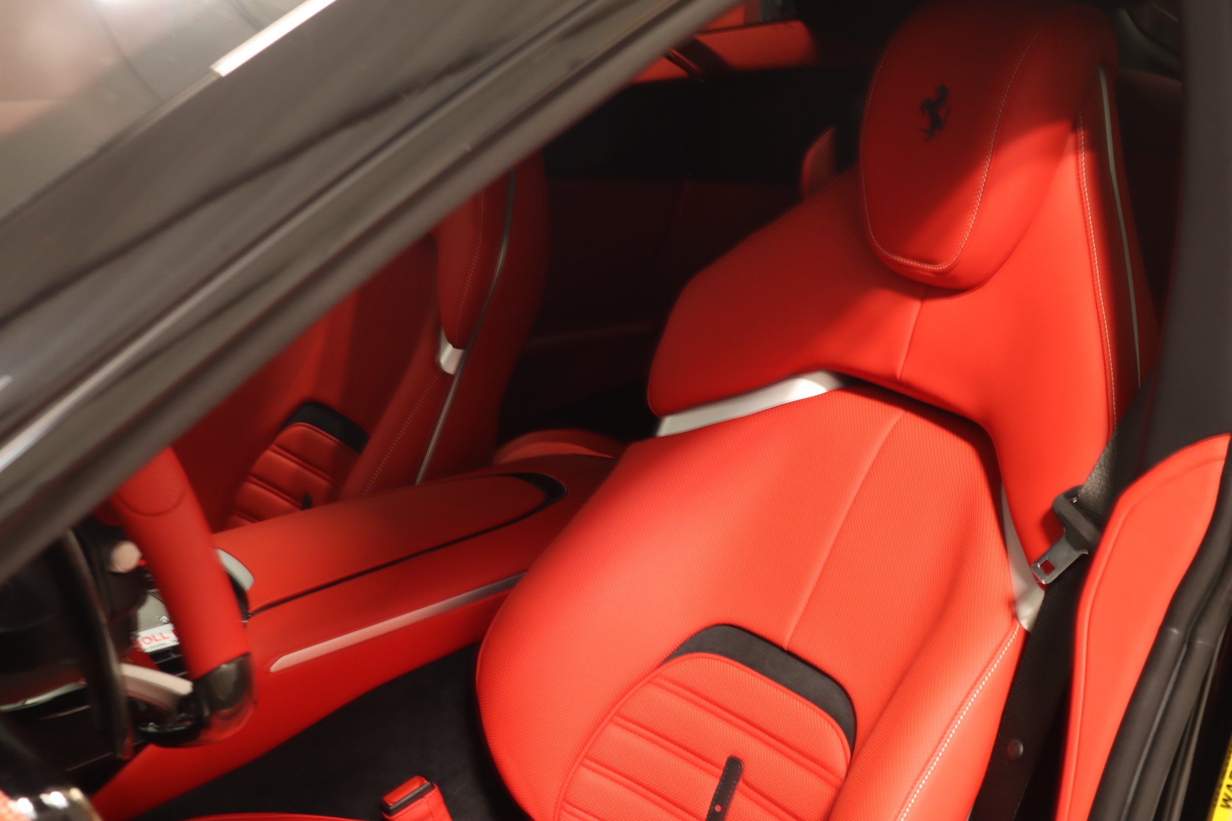 Window tint installation process inside luxury Ferrari Purasangre SUV vehicle at SosaaTintz in Livermore CA