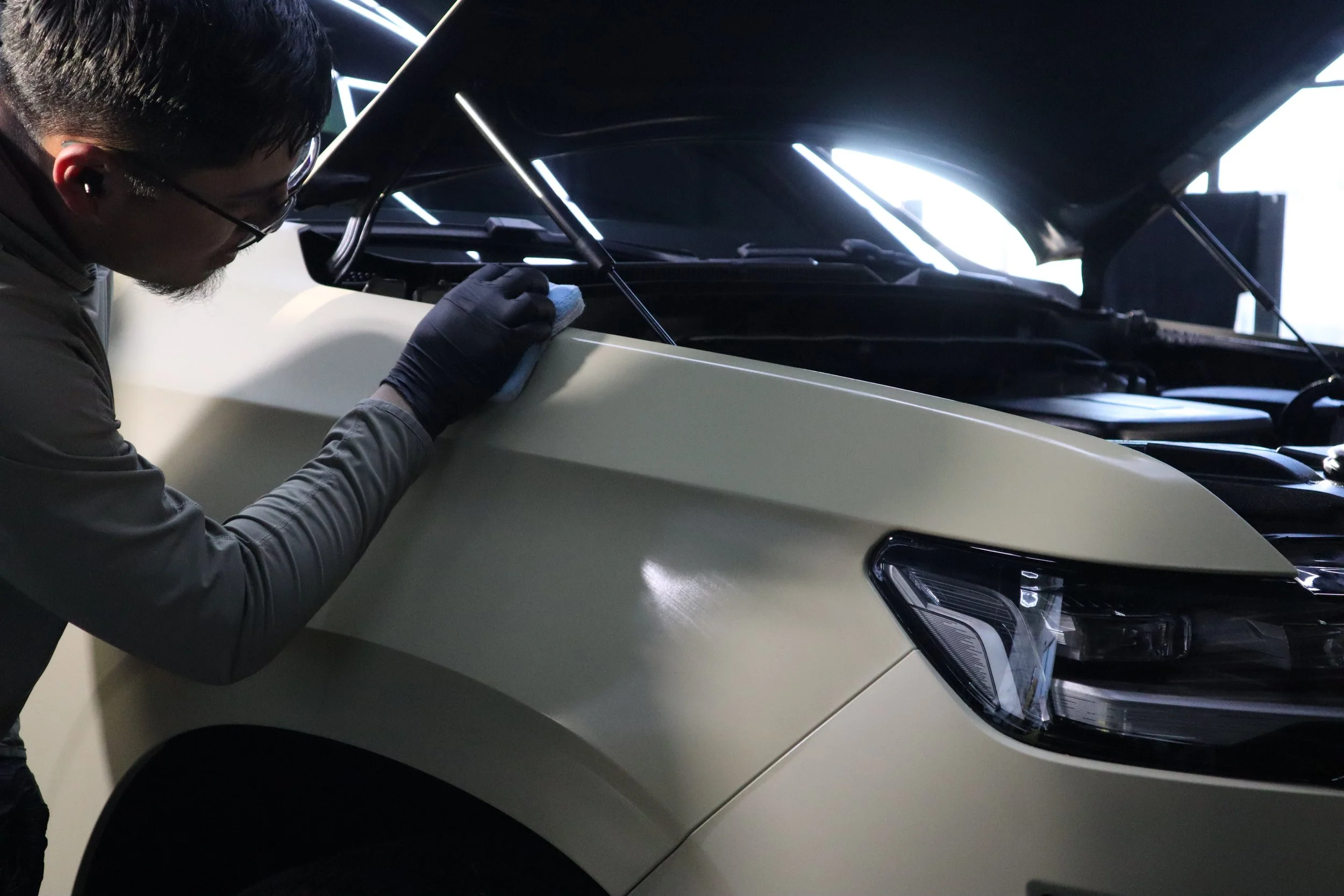 Professional ceramic coating prep on Tesla vehicle inside detailing shop / Sosaatintz shop in Livermore CA
