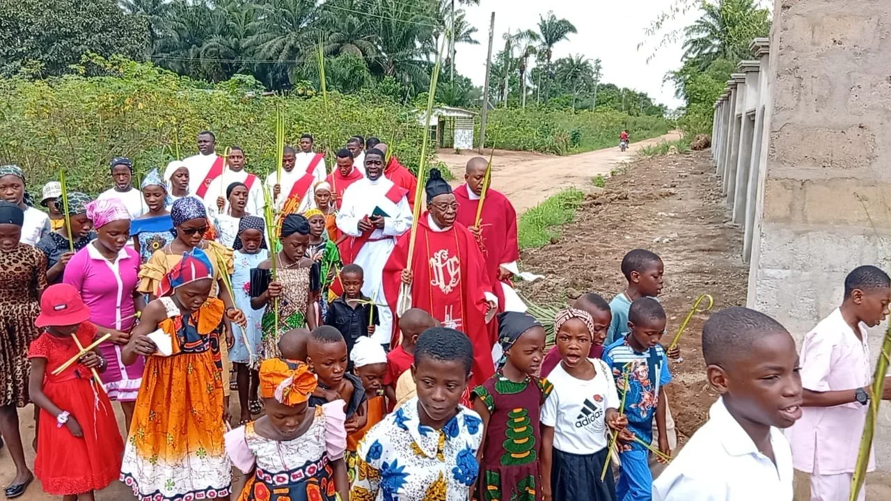 "Celebrating Palm Sunday 2026 at Holy Trinity Chapel, Ohuru, Obingwa, Abia State, Nigeria! The Emmanuelite Community, led by the Founder, joyfully marked Jesus' triumphal entry into Jerusalem, joined by villagers and novices. Vibrant palm branches, h