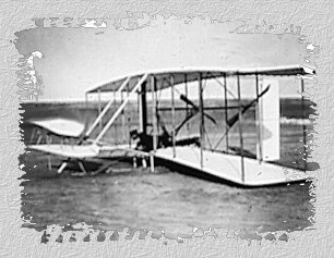 Wilbur Wright in damaged machine after an unsuccessful test, Dec. 14, 1903.