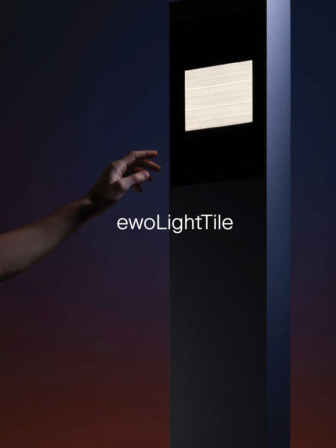 A person reaching towards a tall, black electronic device with a screen, set against a dark background with gradient lighting.