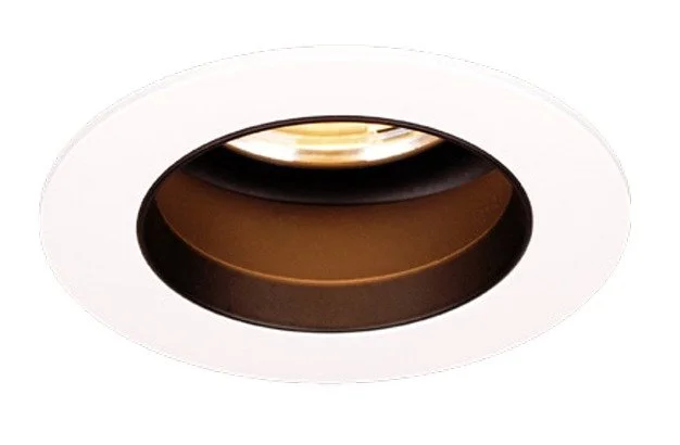 Close-up of a recessed ceiling light fixture with a white outer trim and a dark inner ring.