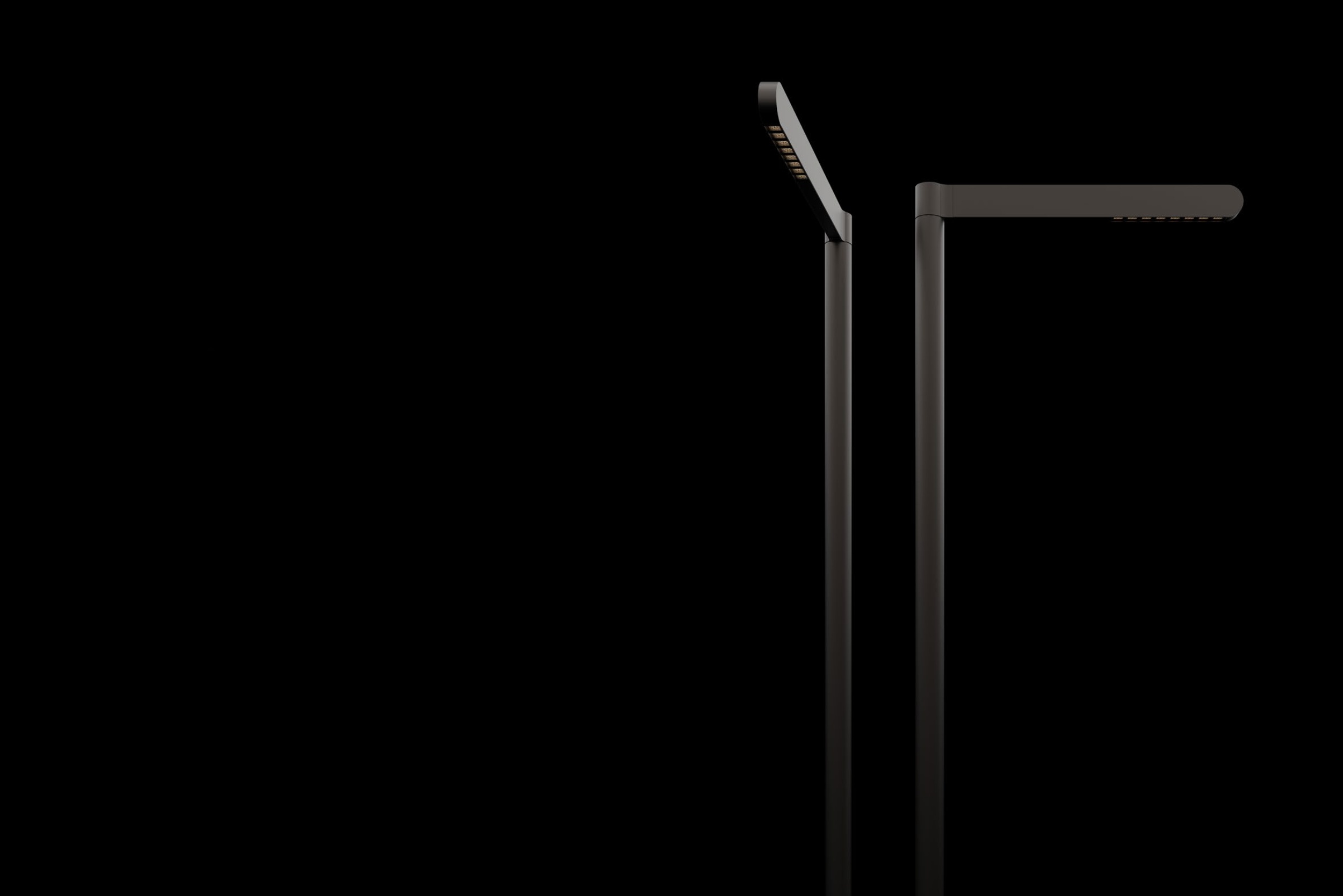 Two modern black streetlights against a black background, one taller with a curved arm and one shorter with a straight arm.