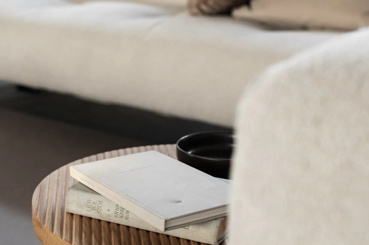 kaboompics_wooden-fluted-table-books-light-beige-sofa-oak-boucle-25042.jpg
