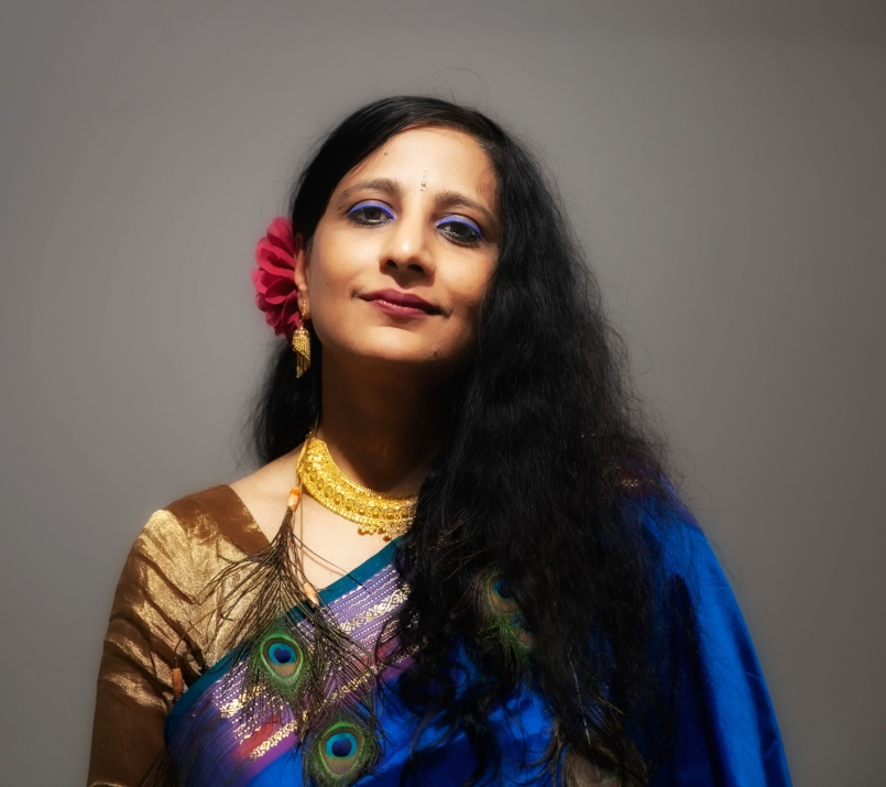 Neha Misra in a sari with a peacock necklace