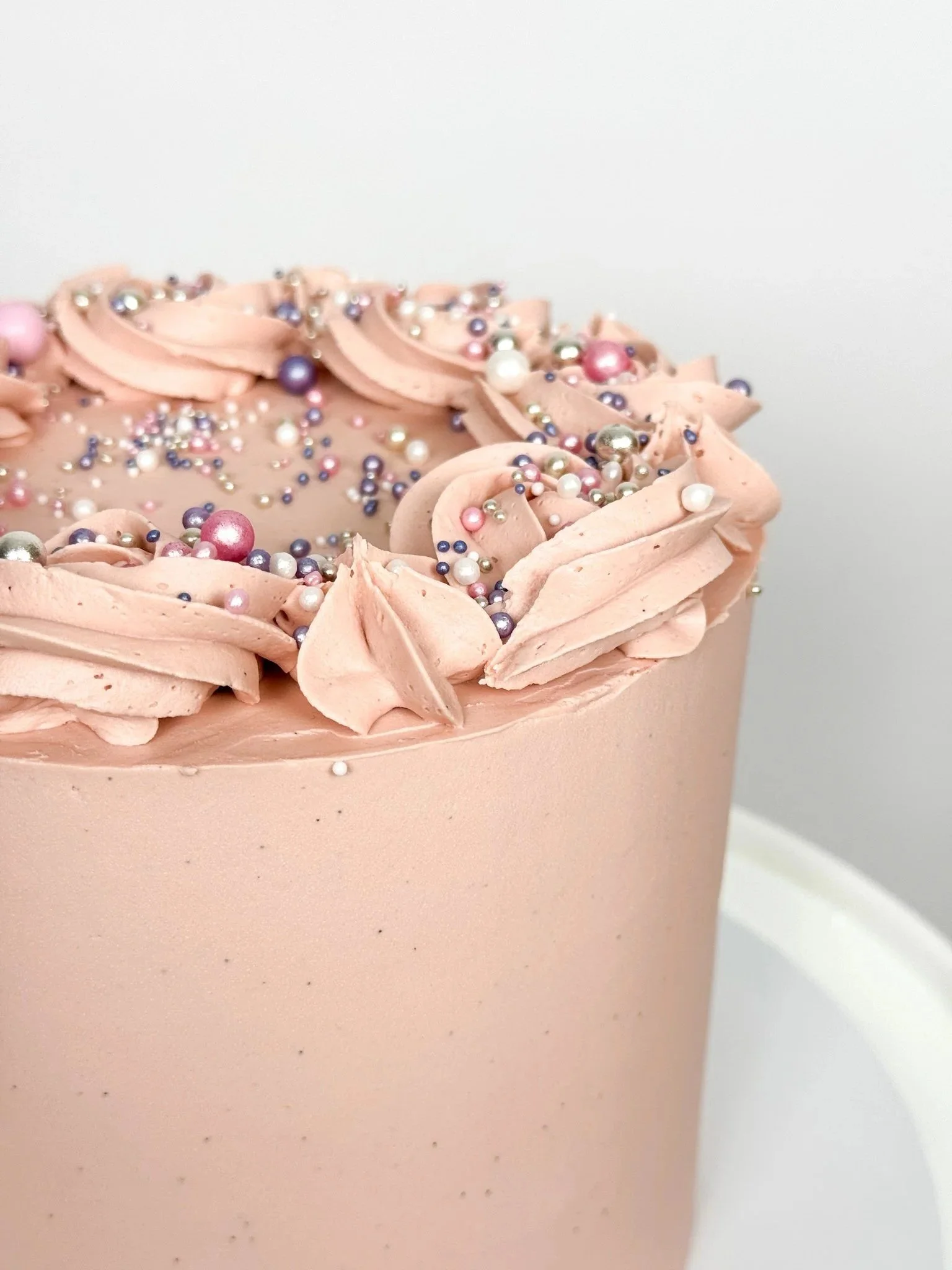Pastel pink buttercream cake with sprinkles