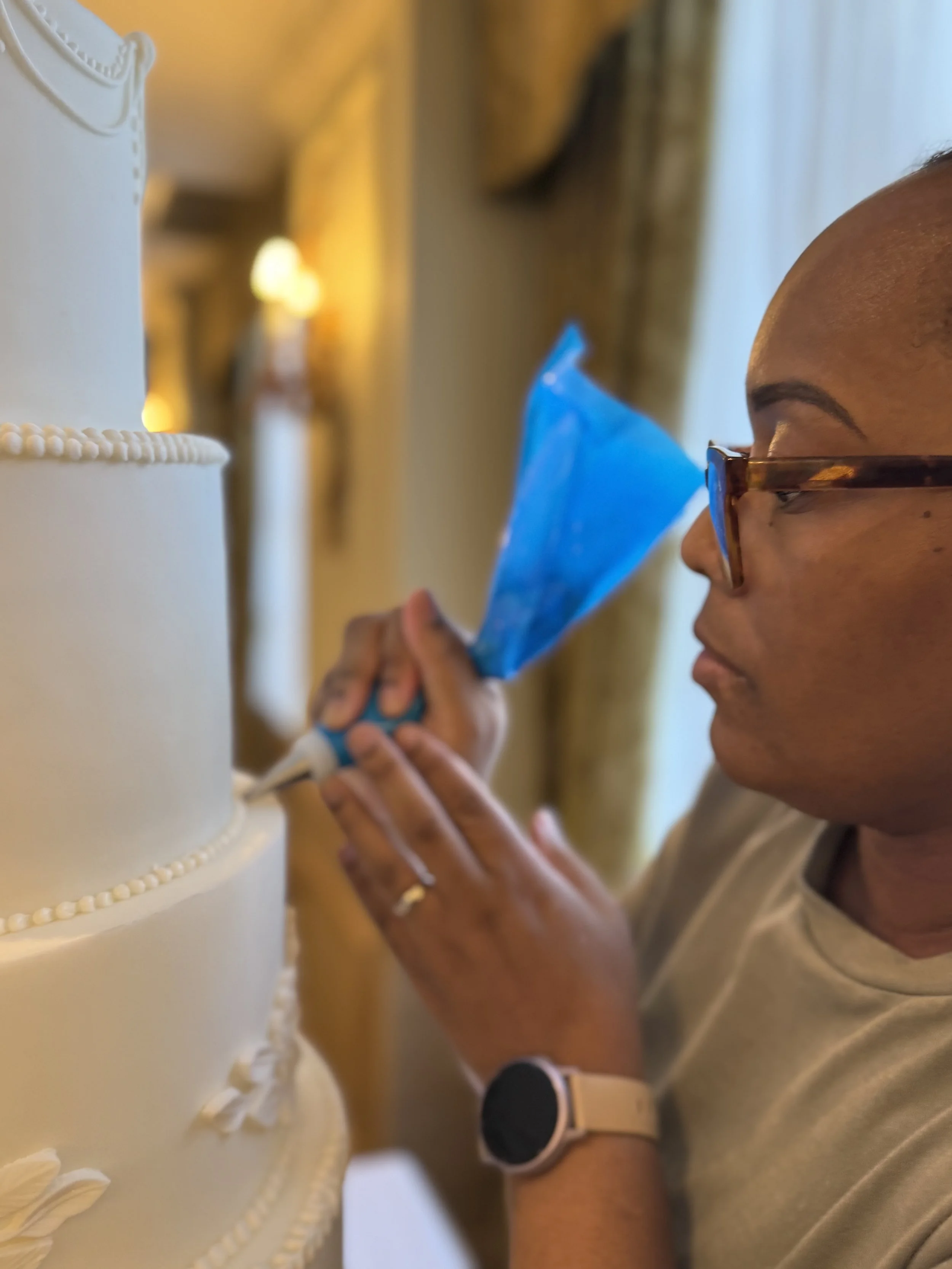 Decorating a wedding cake at The Four Seasons Hotel in London