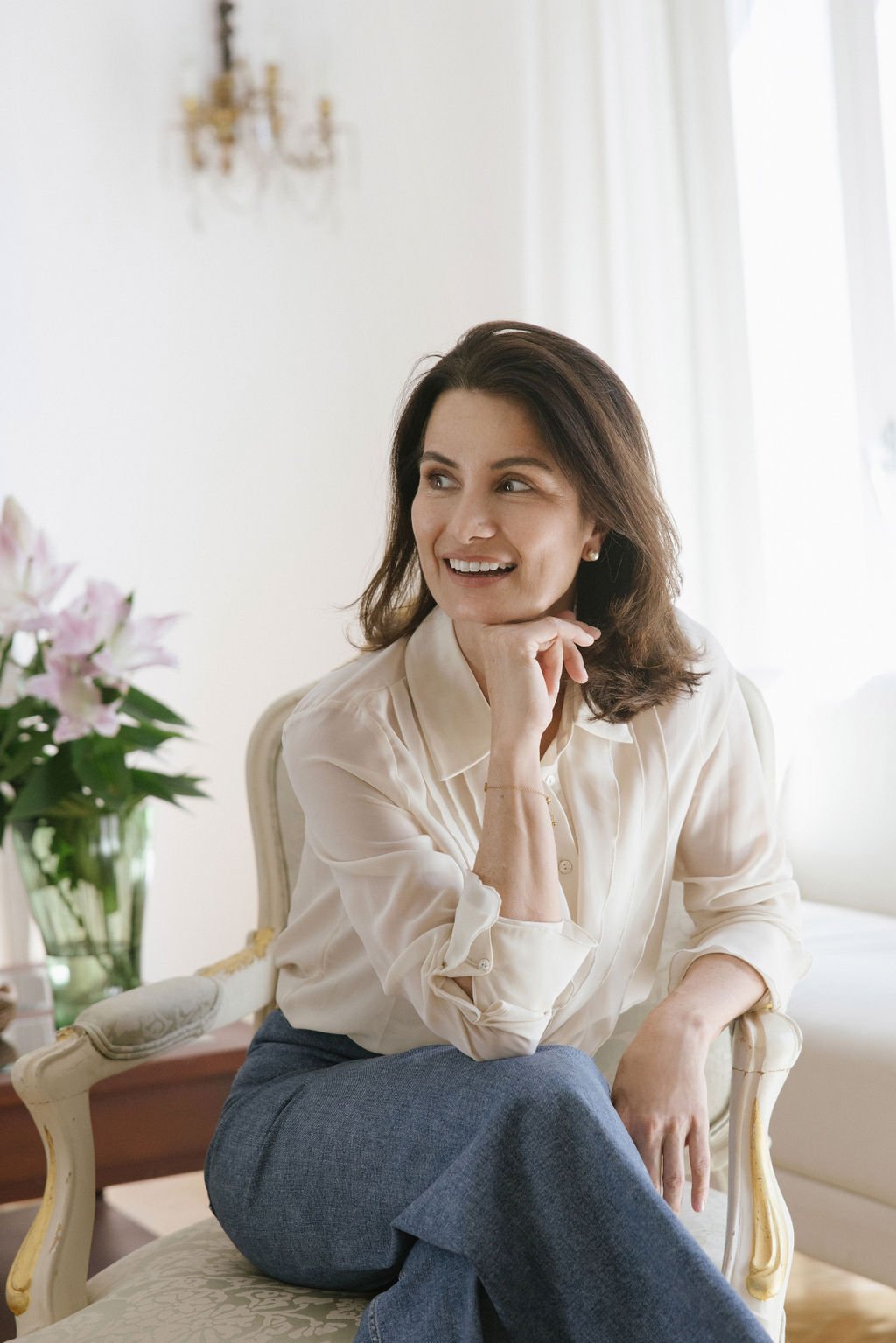 Irene sitting in a chair looking to the side.