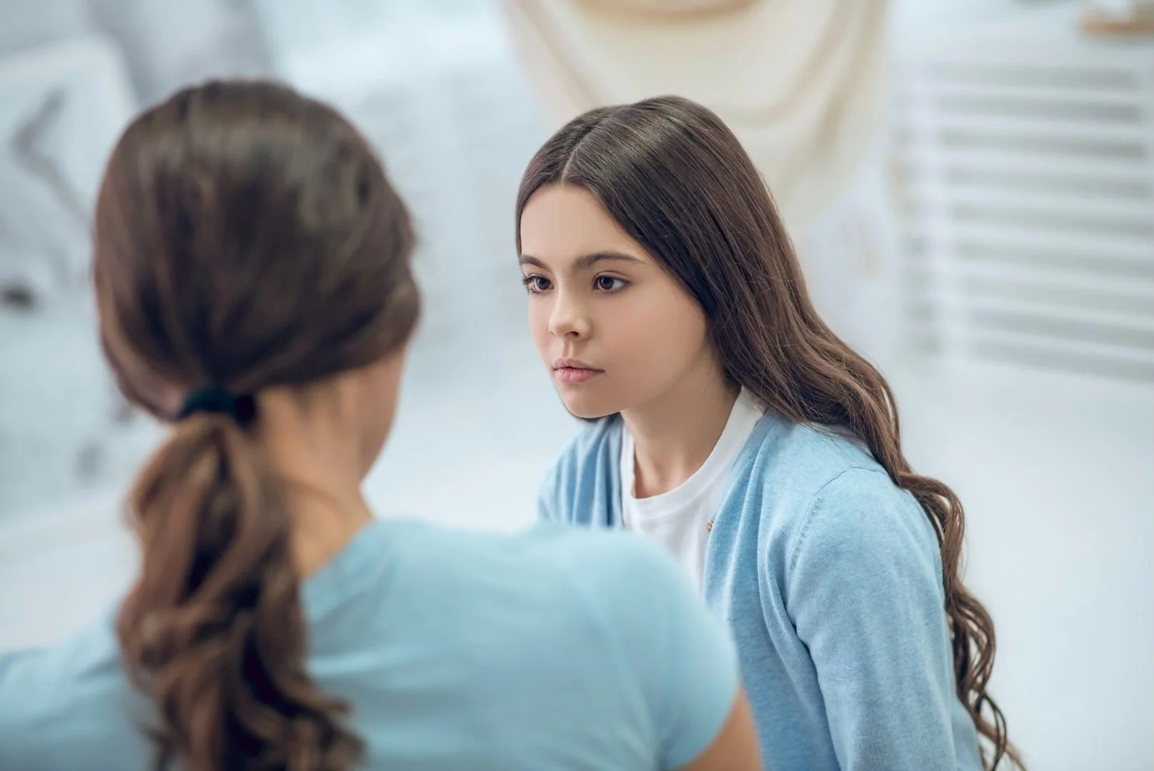 A mom talking with her daughter.
