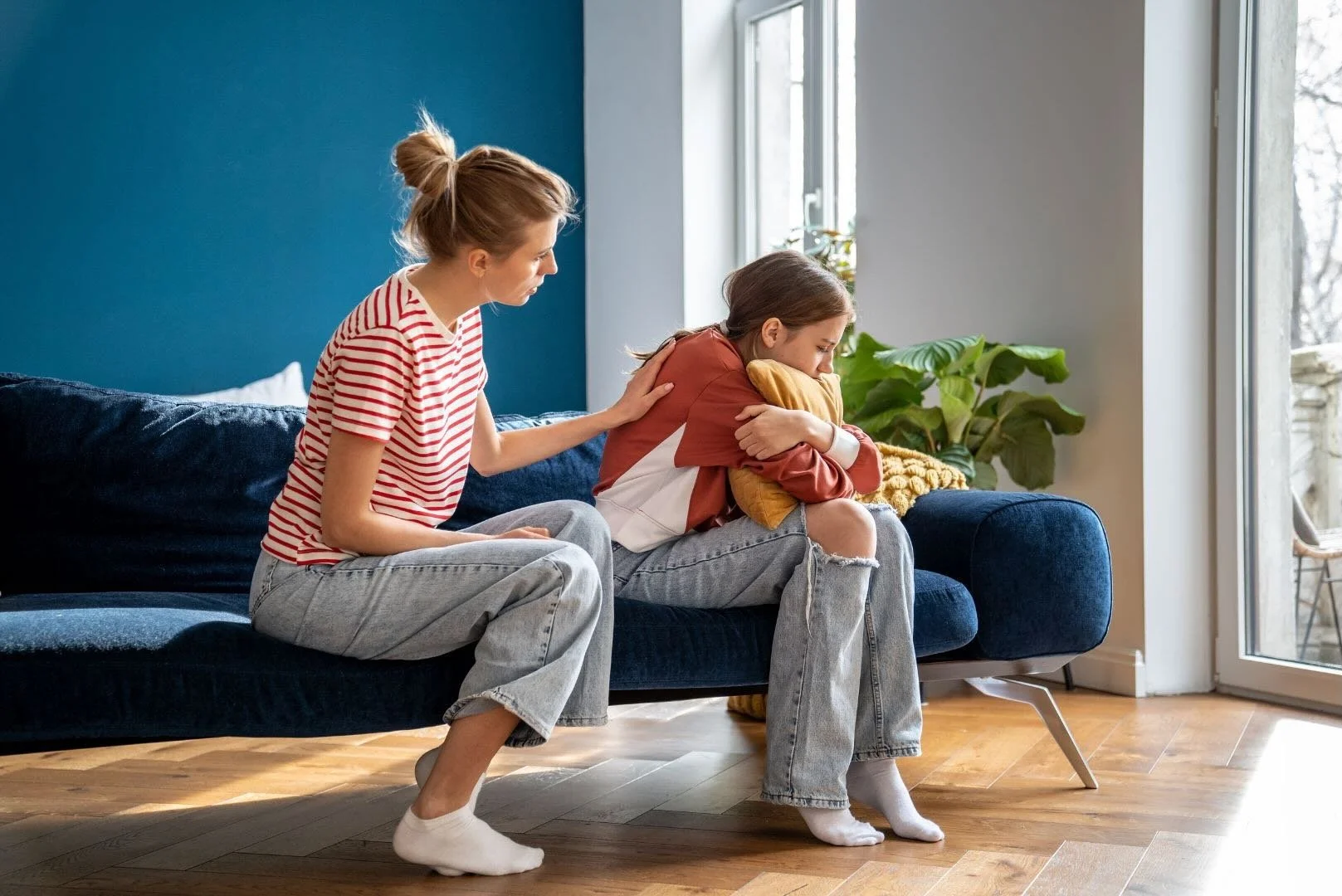 A mom comforting her daughter.
