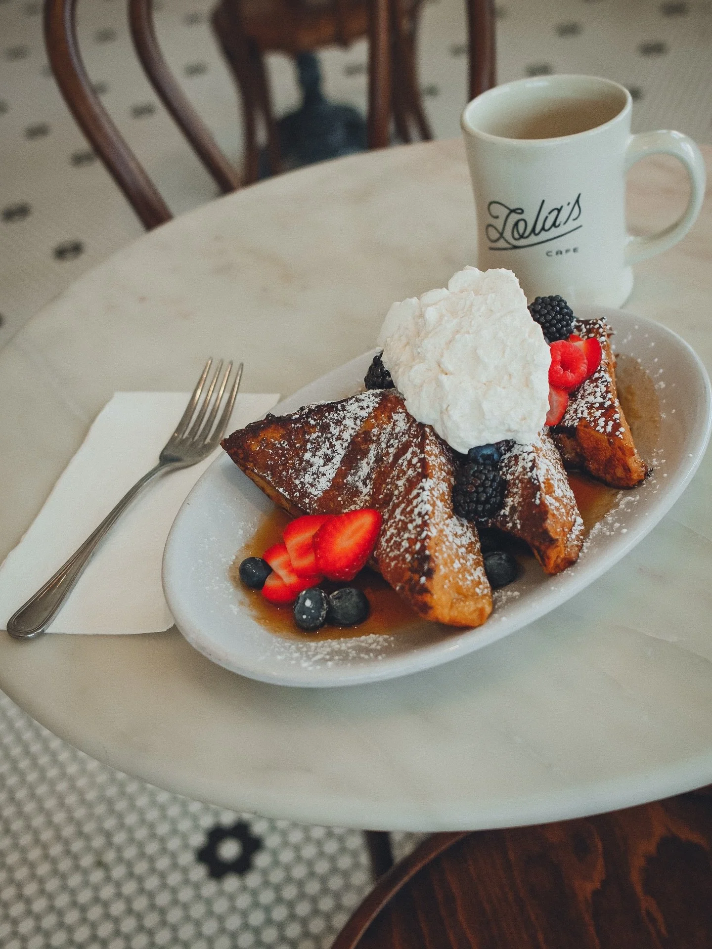 weekend special! thick-cut brioche french toast, warm maple syrup, house made whipped cream, and fresh  berries, here until it's gone! 🍓🫐 and the awning is up... patio season is coming!! outdoor patio opens friday may 8th ☀️