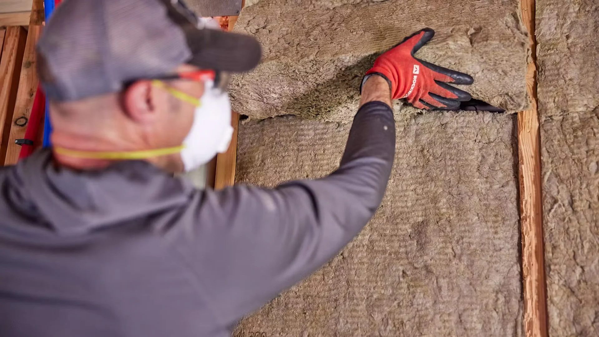 A professional is installing ROCKWOOL insulation on a residential job.