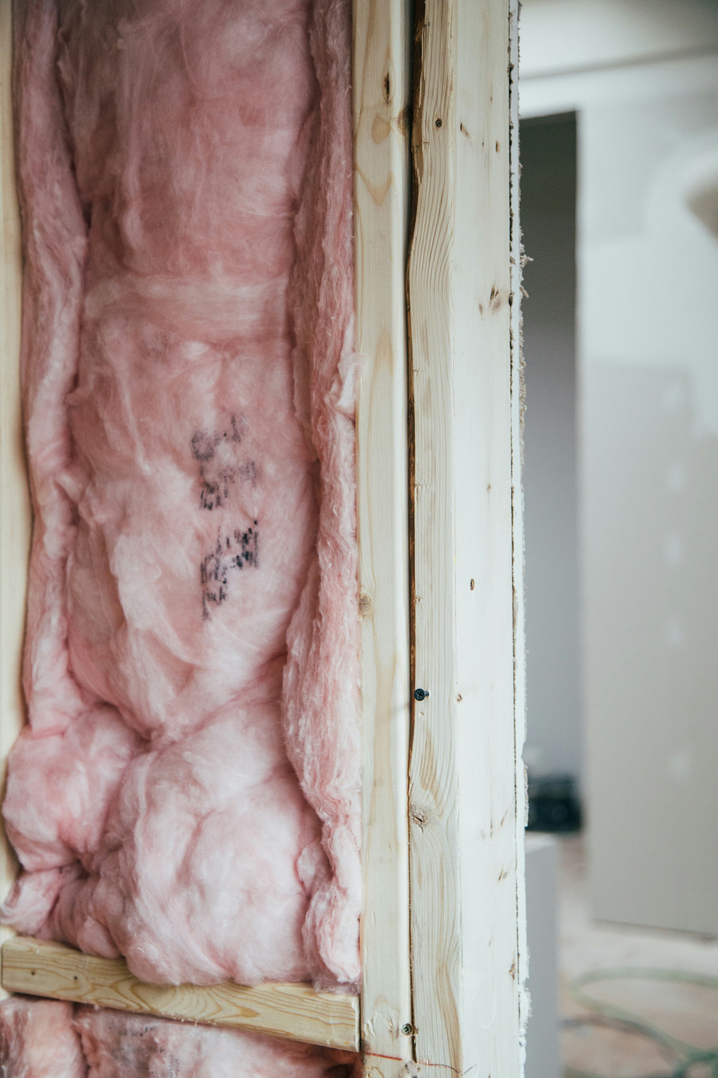Pink batt insulation is installed in an interior wall cavity.