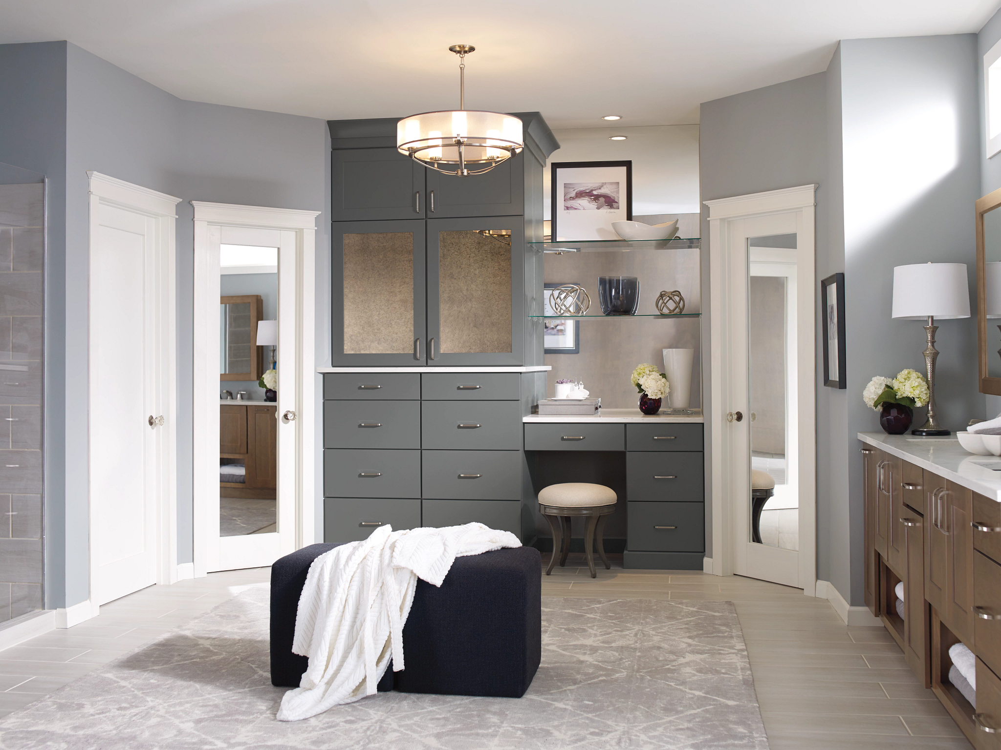 A large master bath with plenty of built-in storage, a double vanity, open-plan shower and seating.