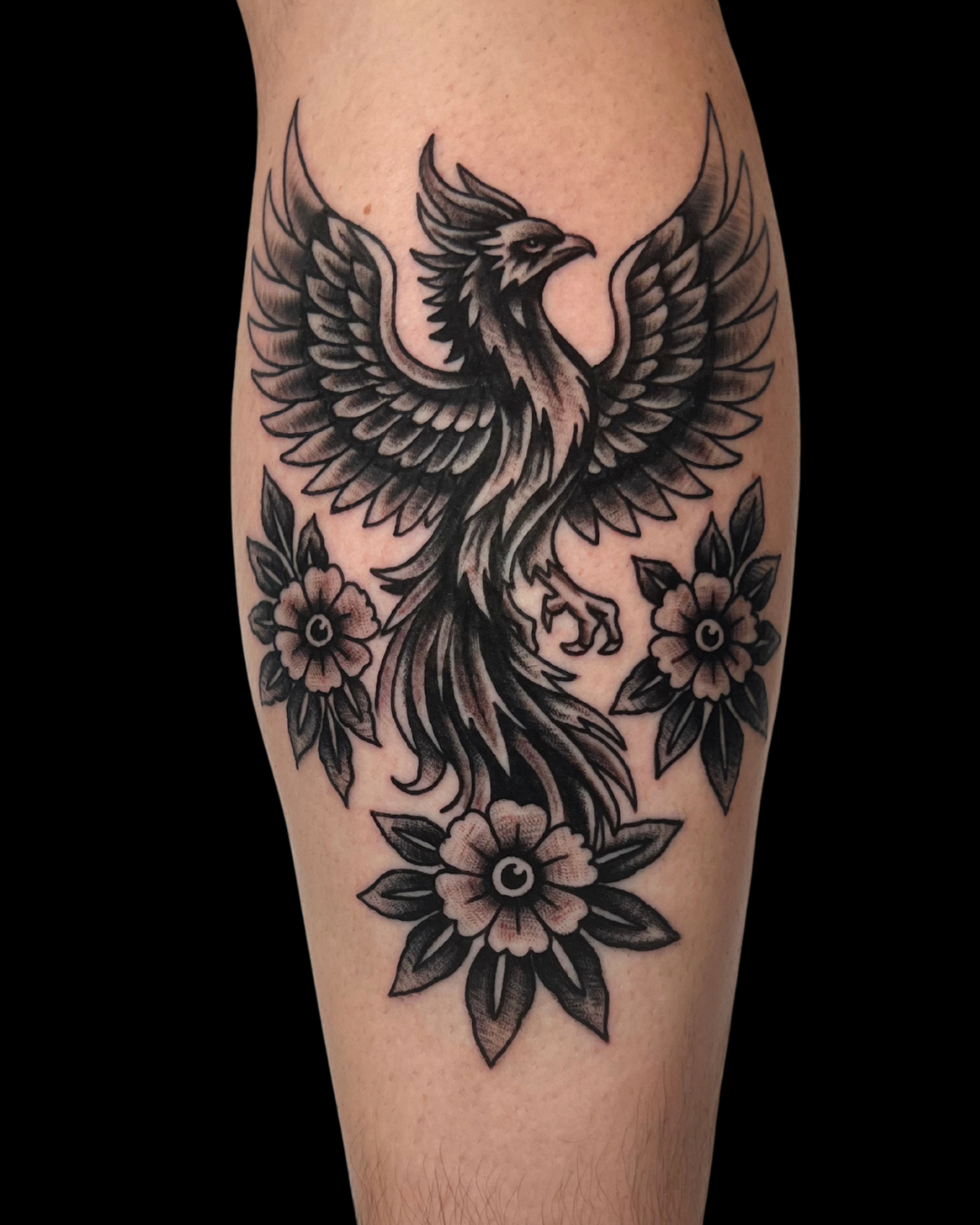 Tattoo of a skull wearing a samurai helmet, with a sword beneath it, on a person's forearm.