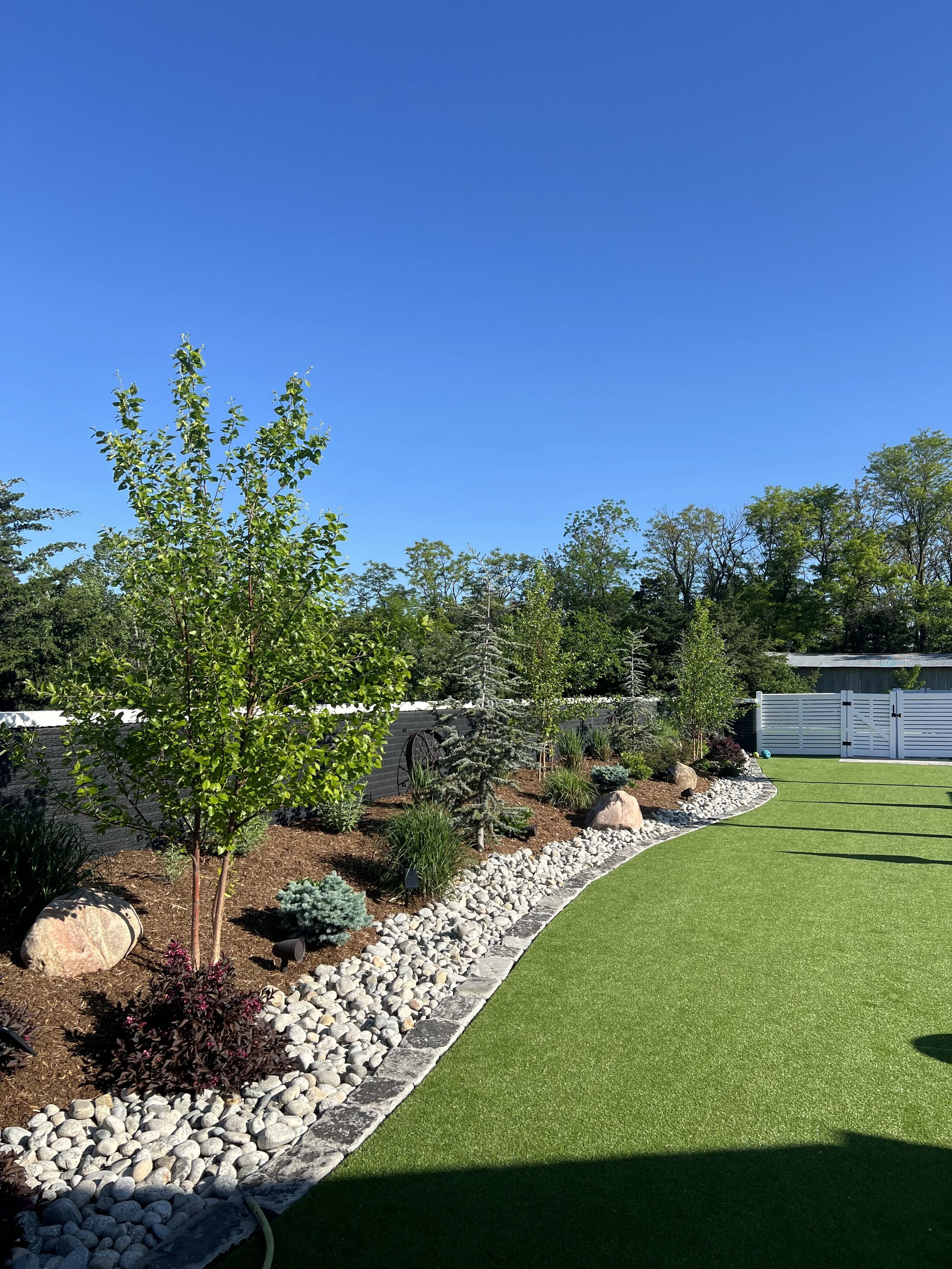 Wichita, KS backyard landscape with trees, grass, flower and turf