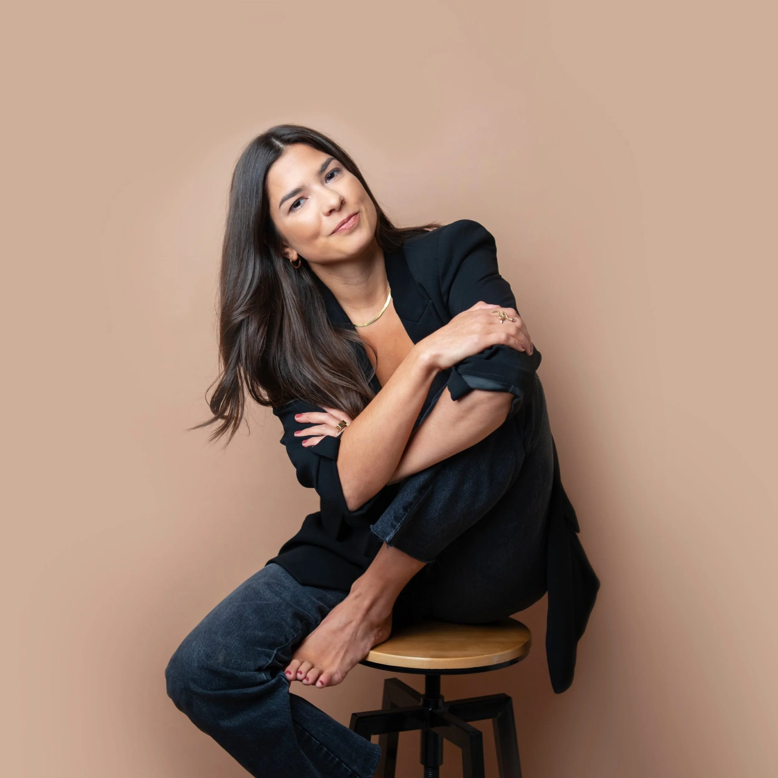 grace-brodeur-smiling-for-the-camera-wearing-a-dark-denim-pants-and-black-business-coat-scaled.jpg