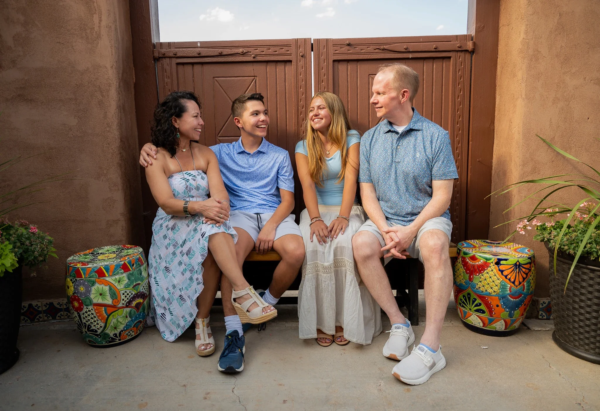 A loving outdoor family portrait with the southwestern aesthetic at The Fort Restaurant in Morrison, Colorado captured by Denver photographer Ryan Kost