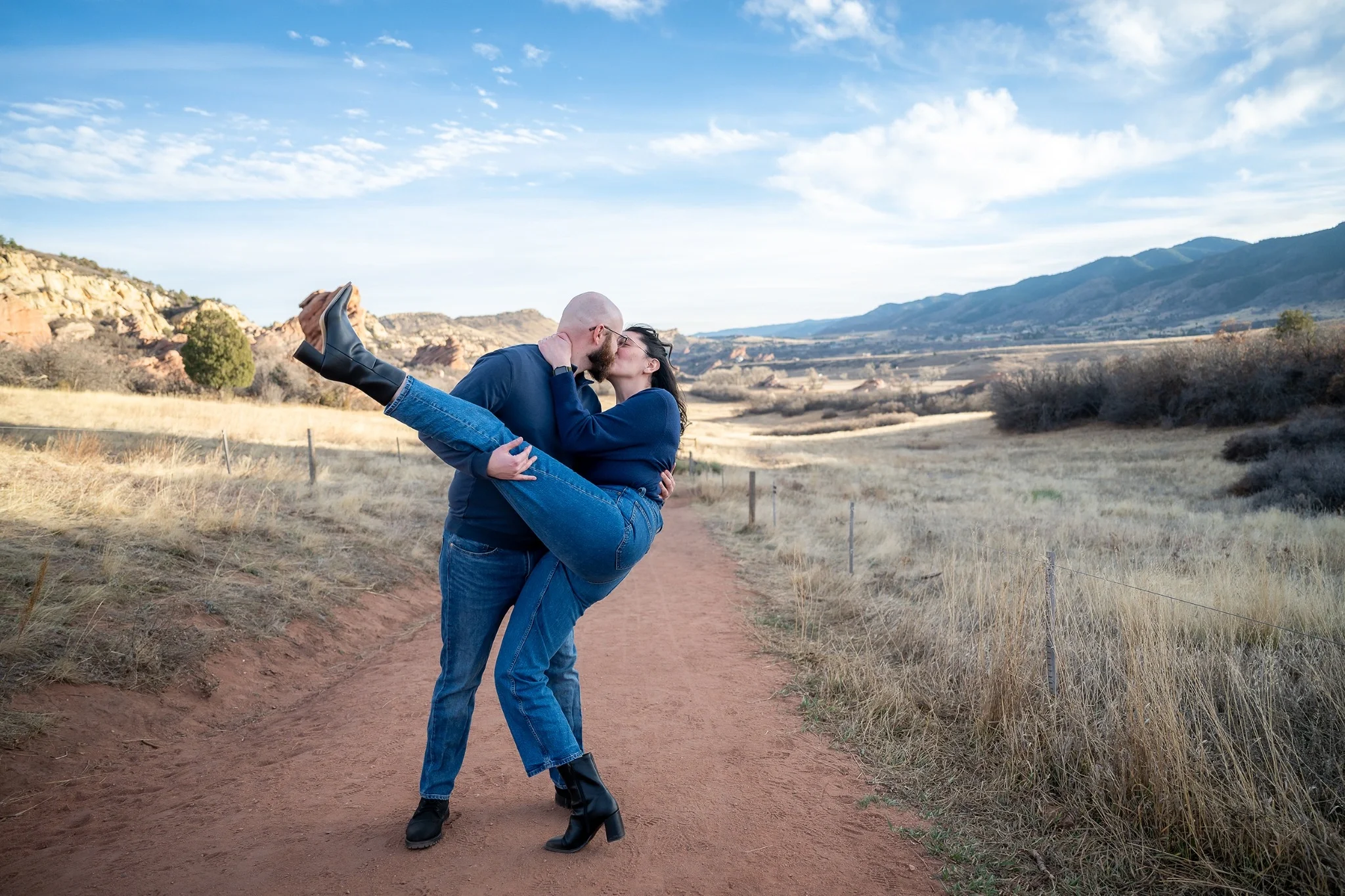 Surprise proposal at South Valley Park in Littleton, Colorado as a couple embraces moments after the engagement, photographed by Ryan Kost