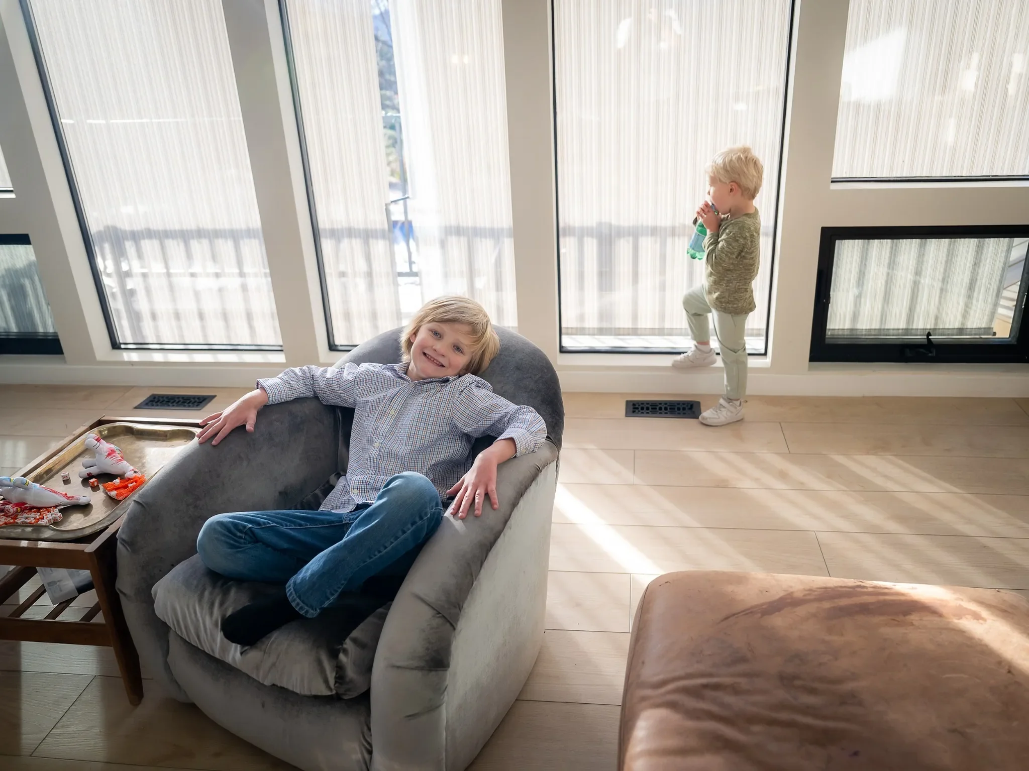 Brothers hanging out in airy living room during an in home family photo session in Indian Hills, Colorado.