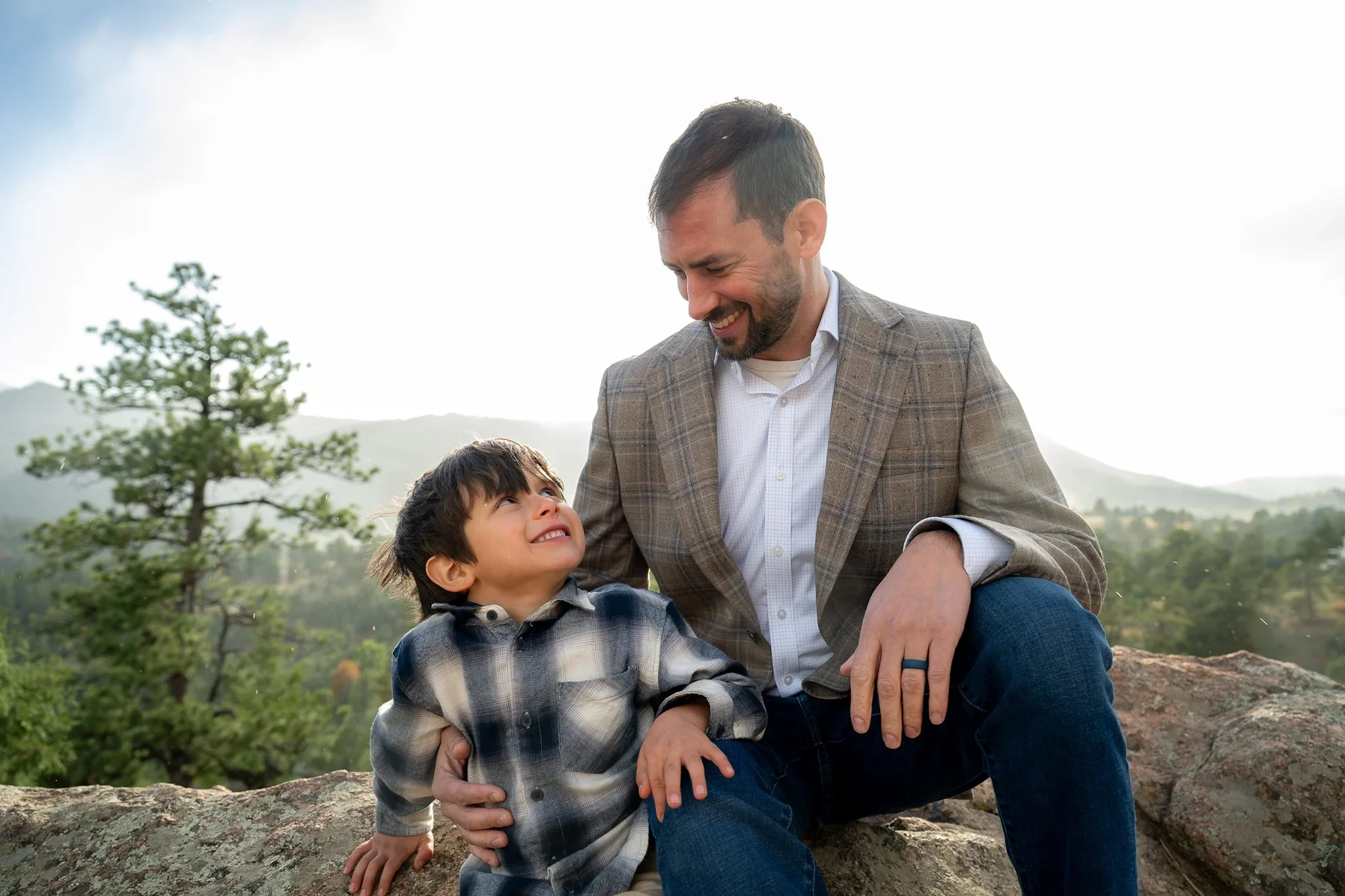 Adoring father and son natural portrait captured during a family phot session at Mount Falcon West in Indian Hills, Colorado. Ryan Kost Photography