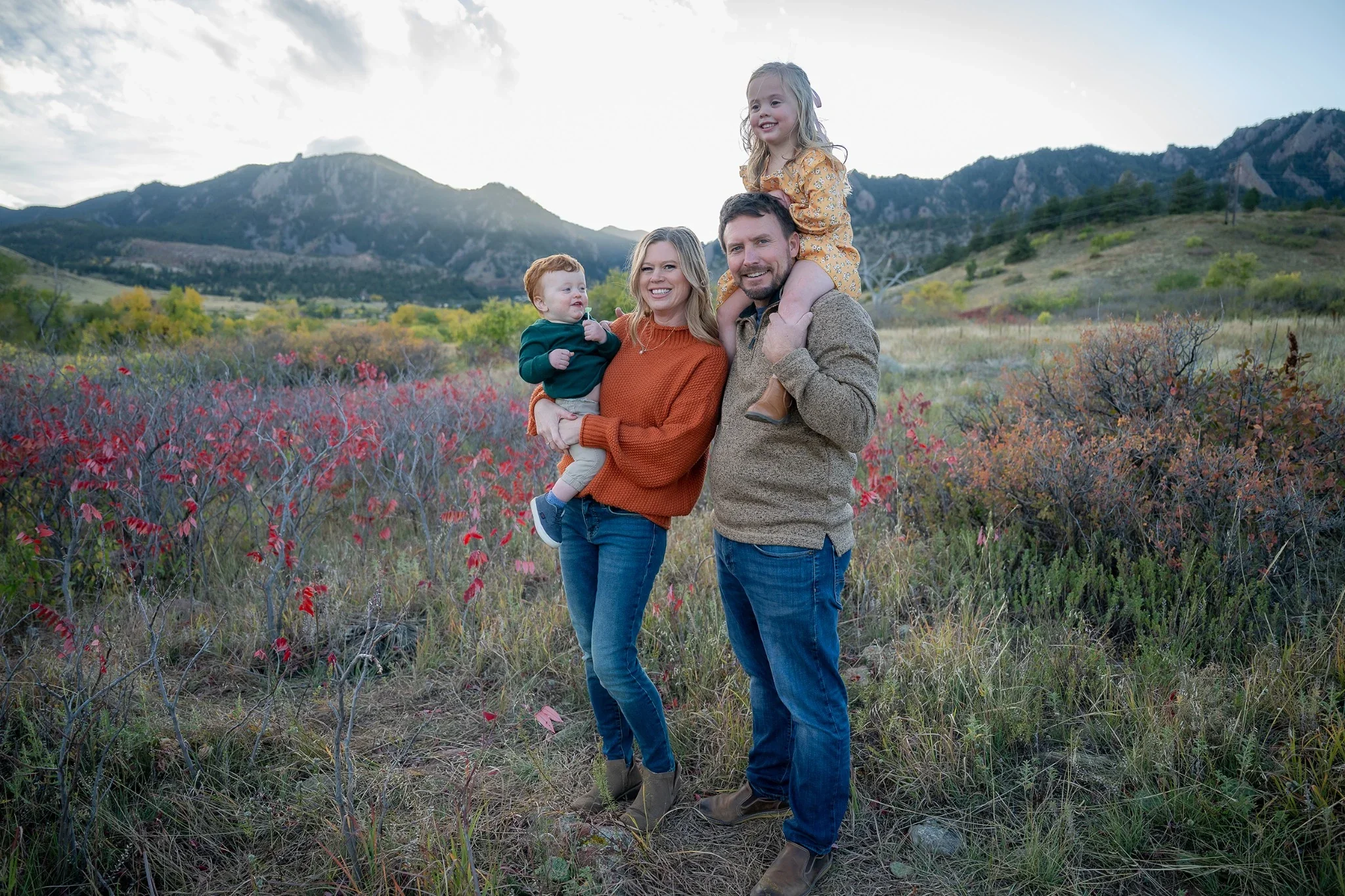 A beautiful fall family portrait with mountain views at South Mesa Trailhead in Boulder, Colorado captured by Ryan Kost.