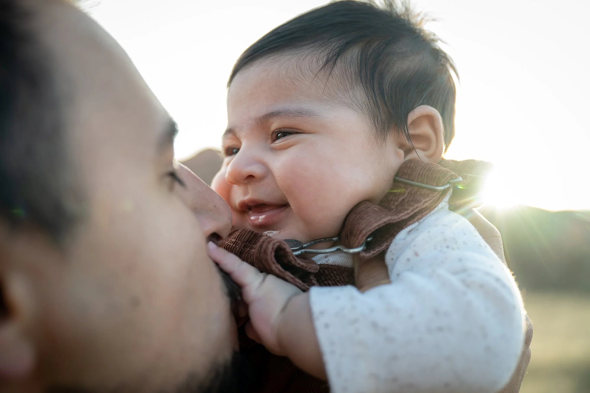 Intimate dad and newborn son portrait in golden hour light captured during a family photo session at South Valley Park in Littleton, Colorado. 