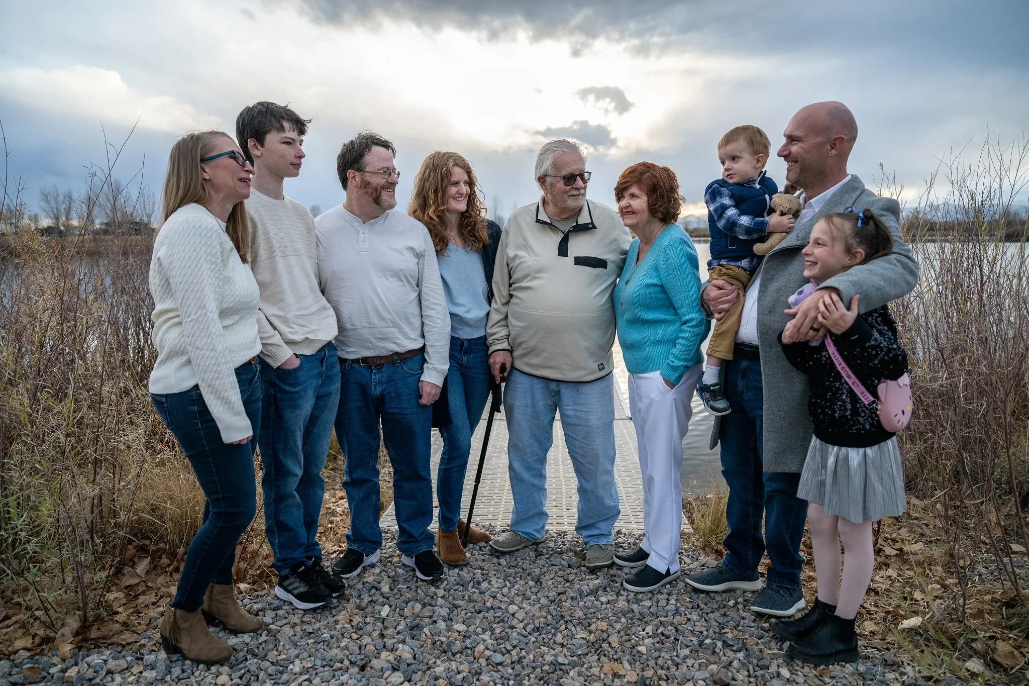 Joyful moments between all generations during a relaxed winter family photoshoot at St. Vrain Lake State Park in Firestone, Colorado captured by Ryan Kost Photography