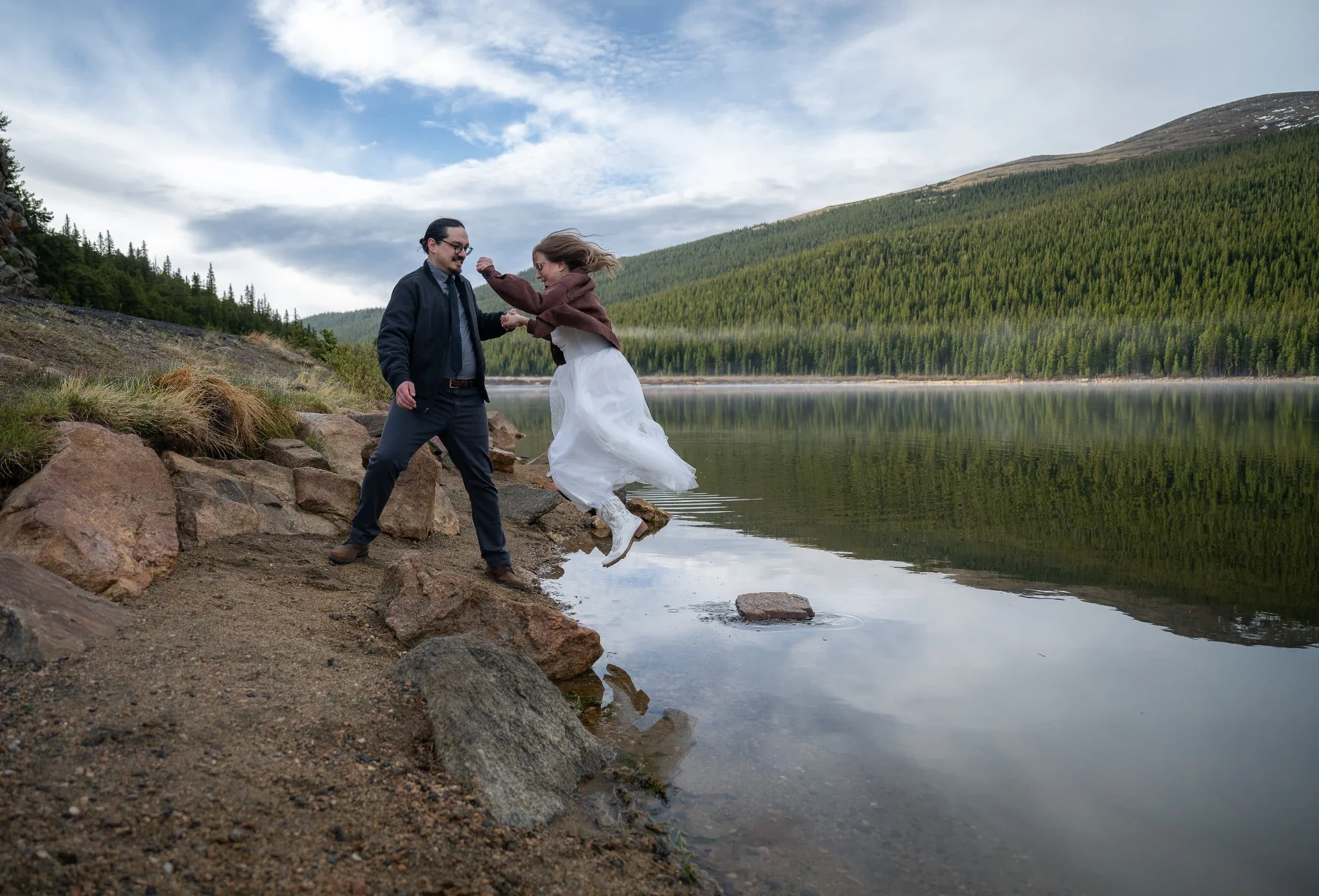 Colorado elopement couple at Echo Lake near Mount Blue Sky, playful lakeside wedding portraits with mountain scenery and forest reflections