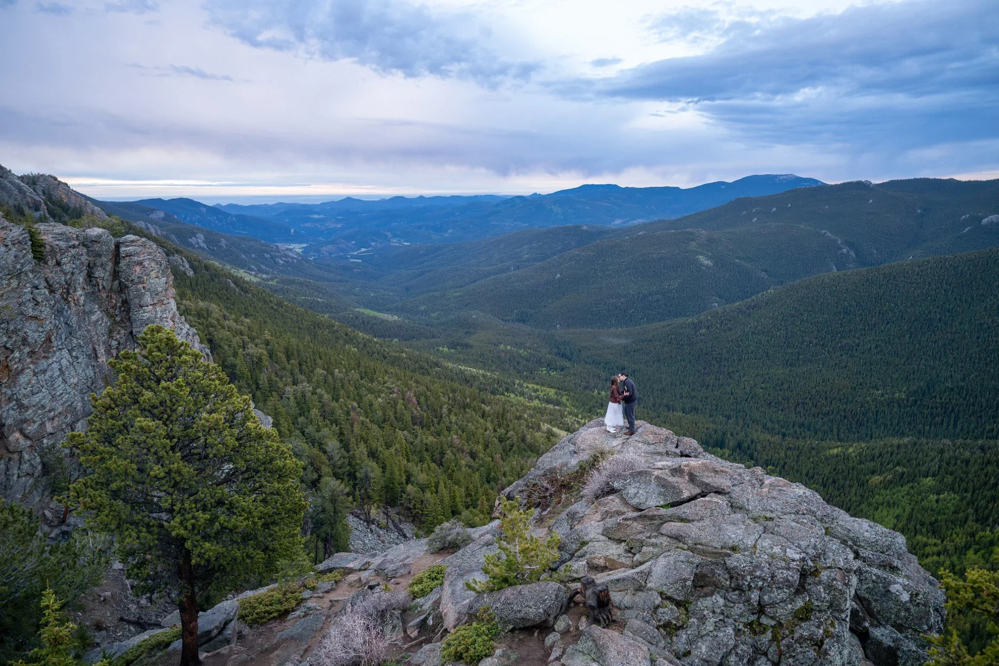 A couple shares their first kiss during a sunrise elopement at Juniper Pass in Colorado captured by Ryan Kost.