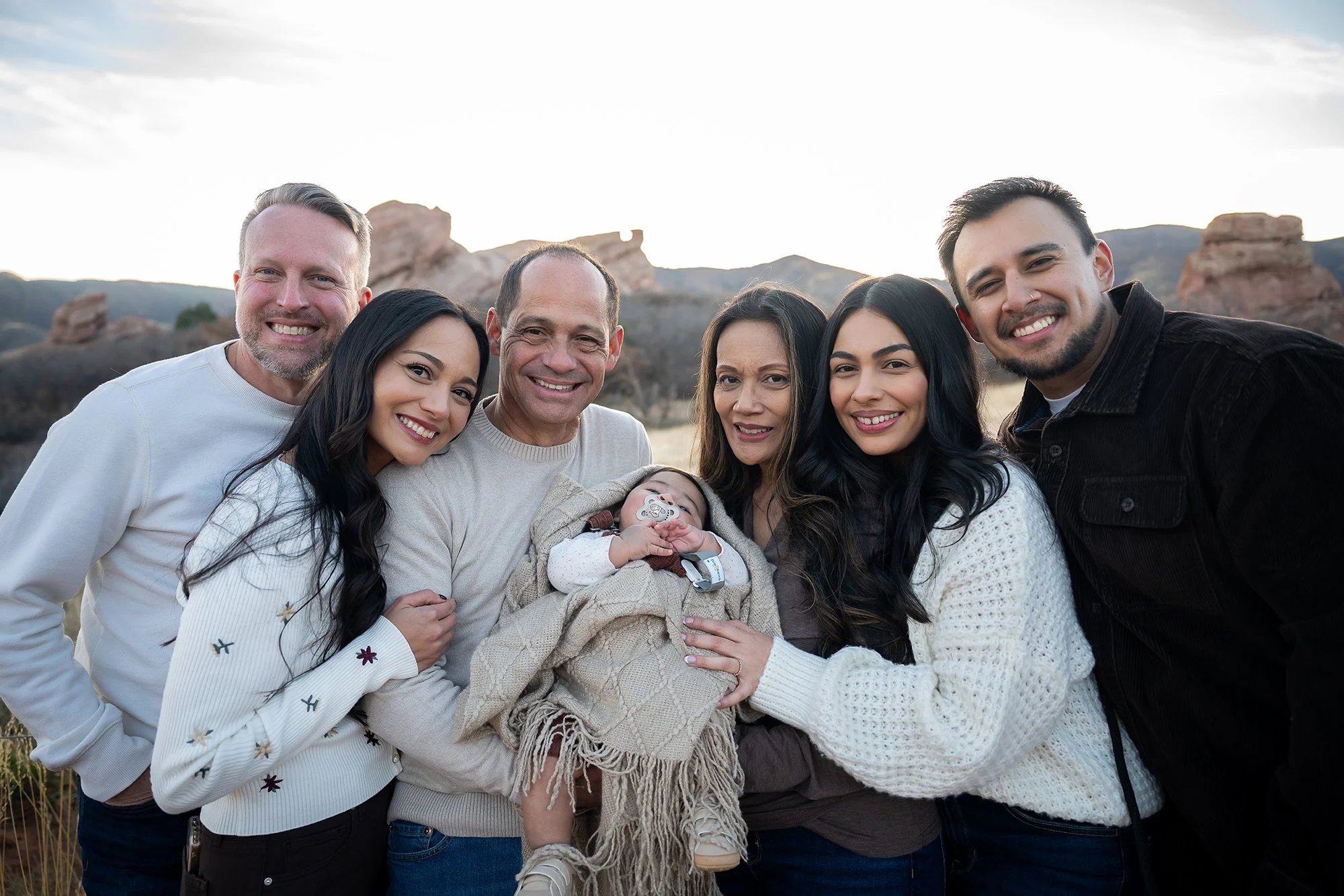Multi-generational, large natural family portrait captured during a golden hour winter session at South Valley Park in Littleton, Colorado. Ryan Kost Photogrpahy