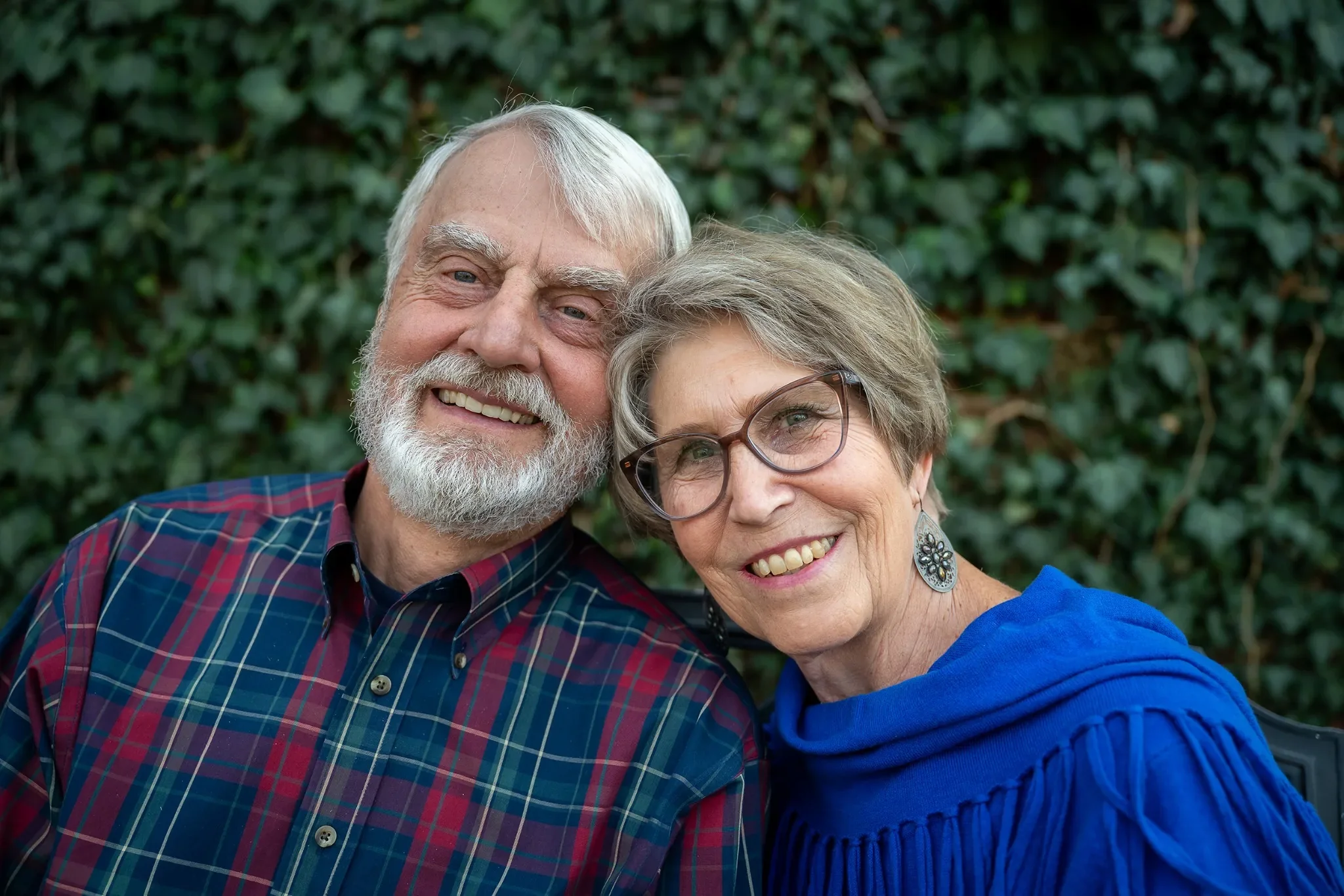 Grandparents loving smiles portrait captured in backyard in Denver, Colorado by Ryan Kost.