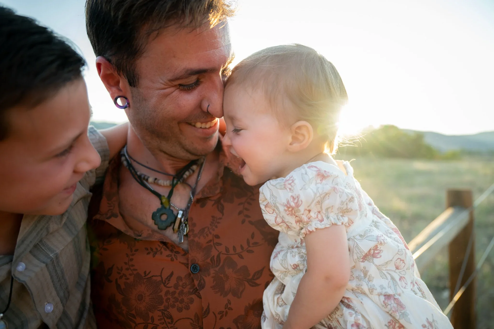 Natural golden hour portrait of dad with his son and daughter at South Valley Park in Littleton, Colorado captured by Ryan Kost.
