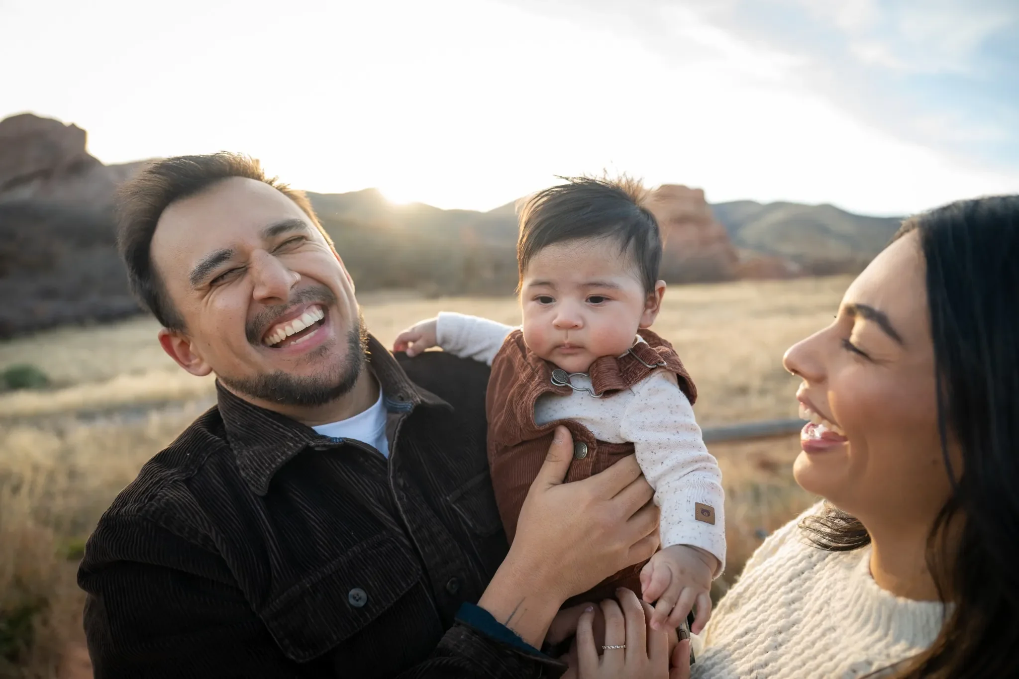 Natural outdoor family portrait with newborn son captured during a golden hour photo session at South Valley Park in Littleton, Colorado.