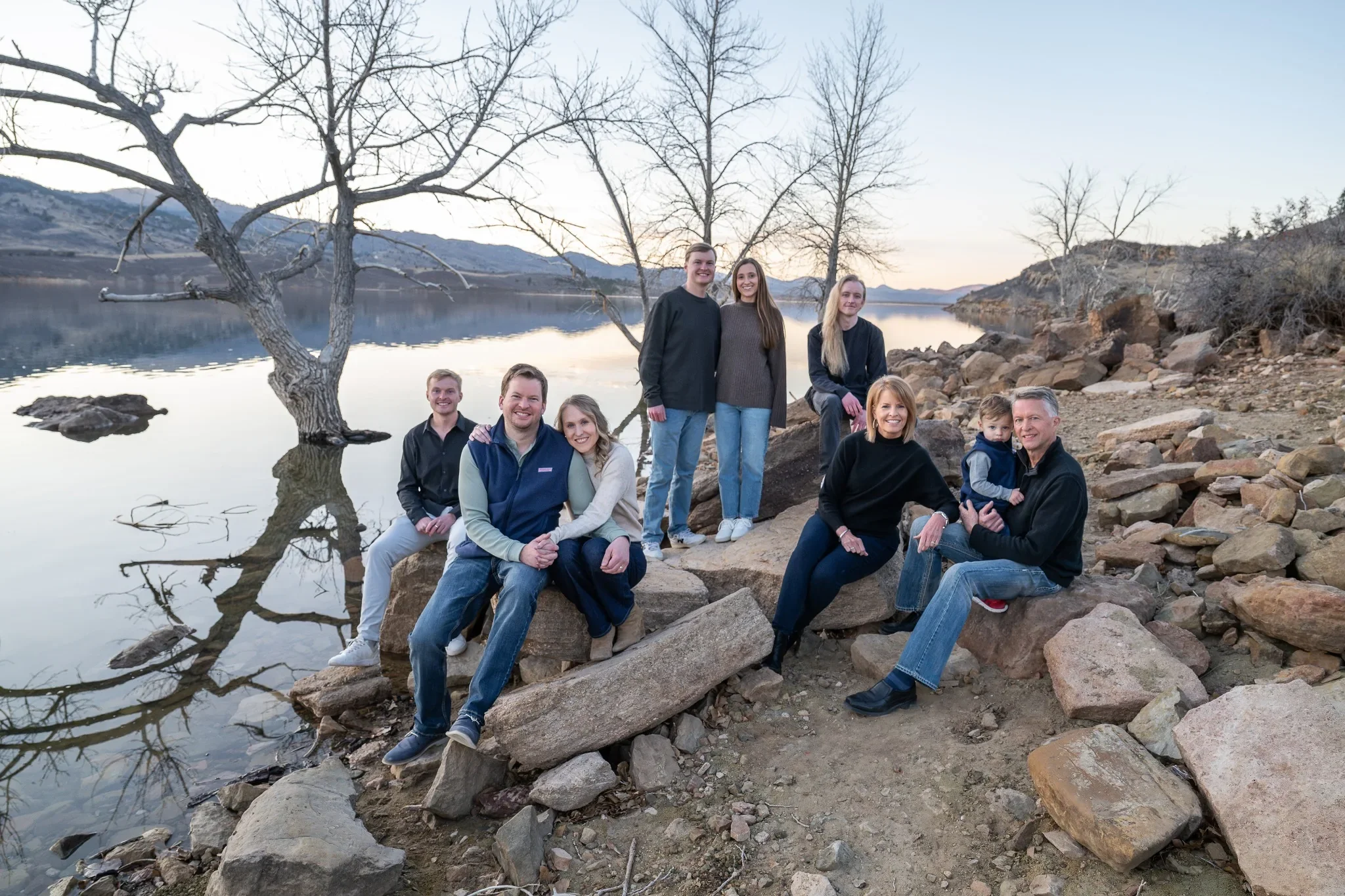 A beautiful natural family portrait lakeside at Horsetooth Reservoir in Fort Collins, Colorado. Relaxed winter family photography captured by Ryan Kost