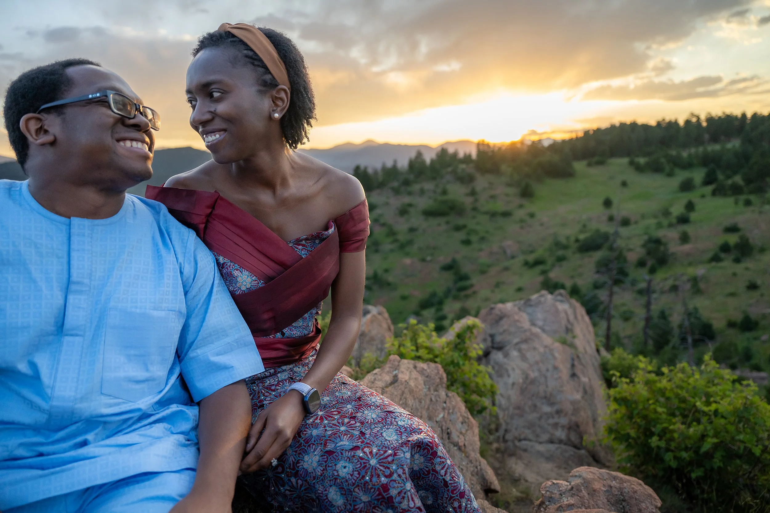 Newlyweds give loving looks enjyoing a summer Colorado sunset at Mount Falcon West Trailhead. Captured by Ryan Kost.