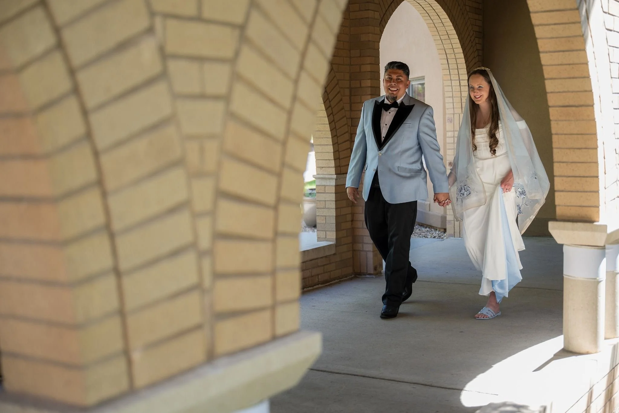 Walking outside of the chapel. A deeply heartfelt and dramatic elopement at Spirit of Christ Church in Colorado, styled with natural light and an intimate, soulful lens by Ryan Kost.