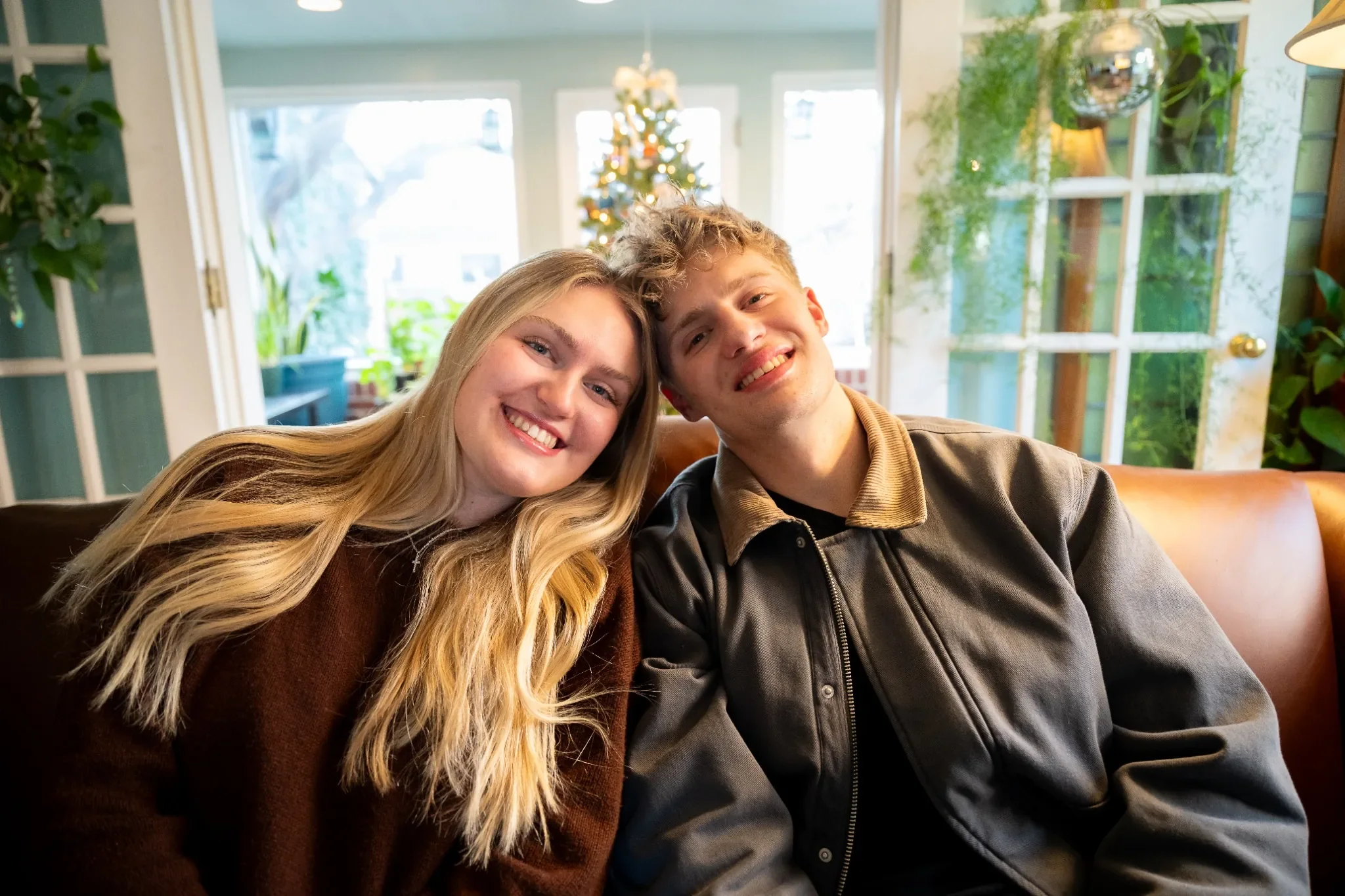 Loving siblings portrait in home in front of Christmas Tree in Denver, Colorado. Ryan Kost Photography