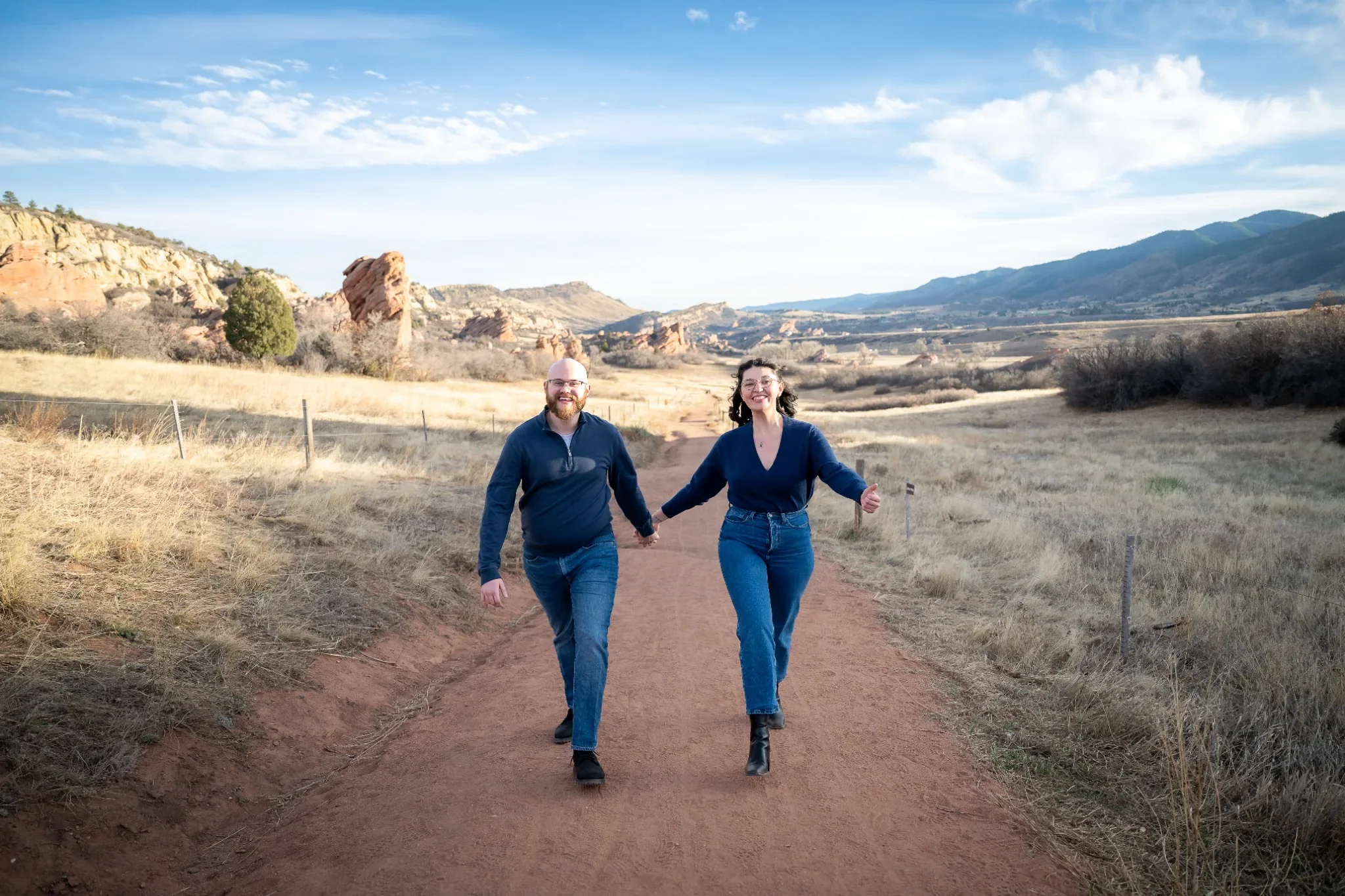 Couple walking arm in arm during a relaxed family photo session at South Valley Park in Littleton, Colorado. Ryan Kost Photography