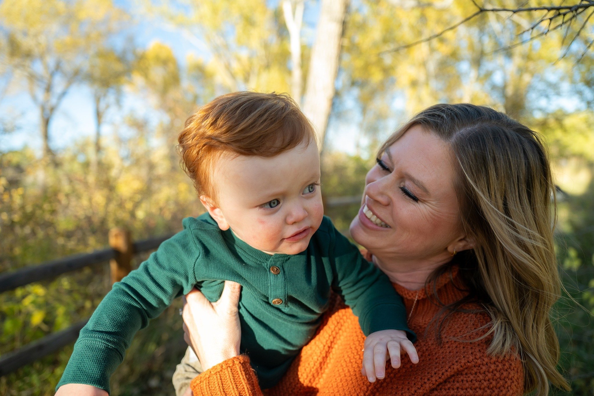 Mom holds son giving loving looks. South Mesa Trailhead in Boulder, Colorado. Ryan Kost natural, relaxed family photography.