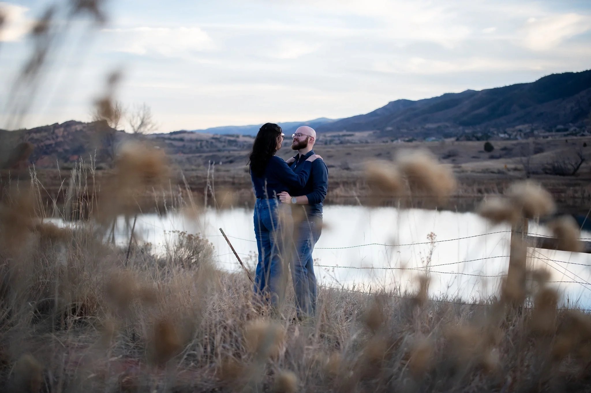 A couple enjoys an intimate moment after getting engaged at South Valley Park in Littleton, Colorado. Ryan Kost Photography.