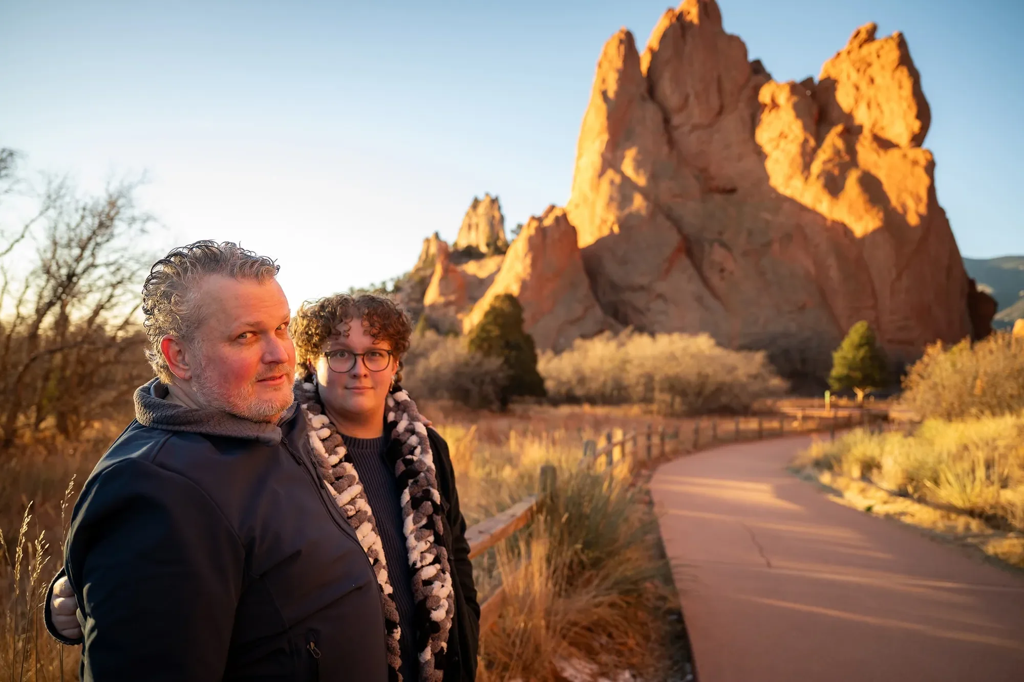 Silly dad and son portrait during a sunrise photo session at Garden of the Gods in Colorado Springs captured by Ryan Kost Photography.