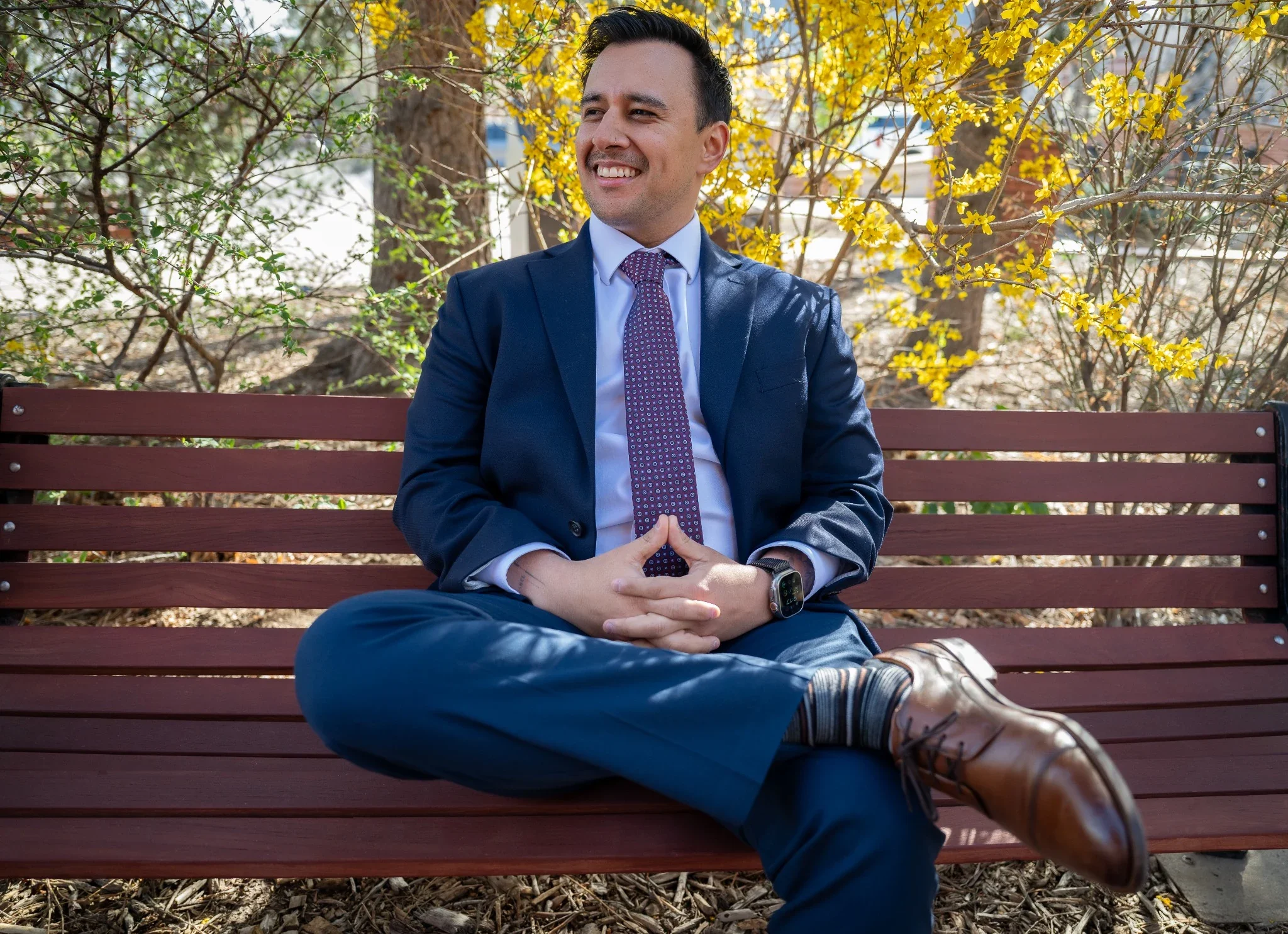 Relaxed, natural business portrait sitting on bench in downtown Golden, Colorado. 