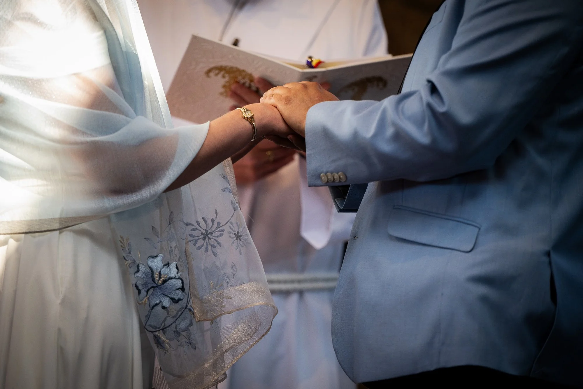 Saying vows. A stunning fusion of natural light and dramatic color, this church elopement in Arvada, CO is both intimate and visually striking, captured by Ryan Kost.