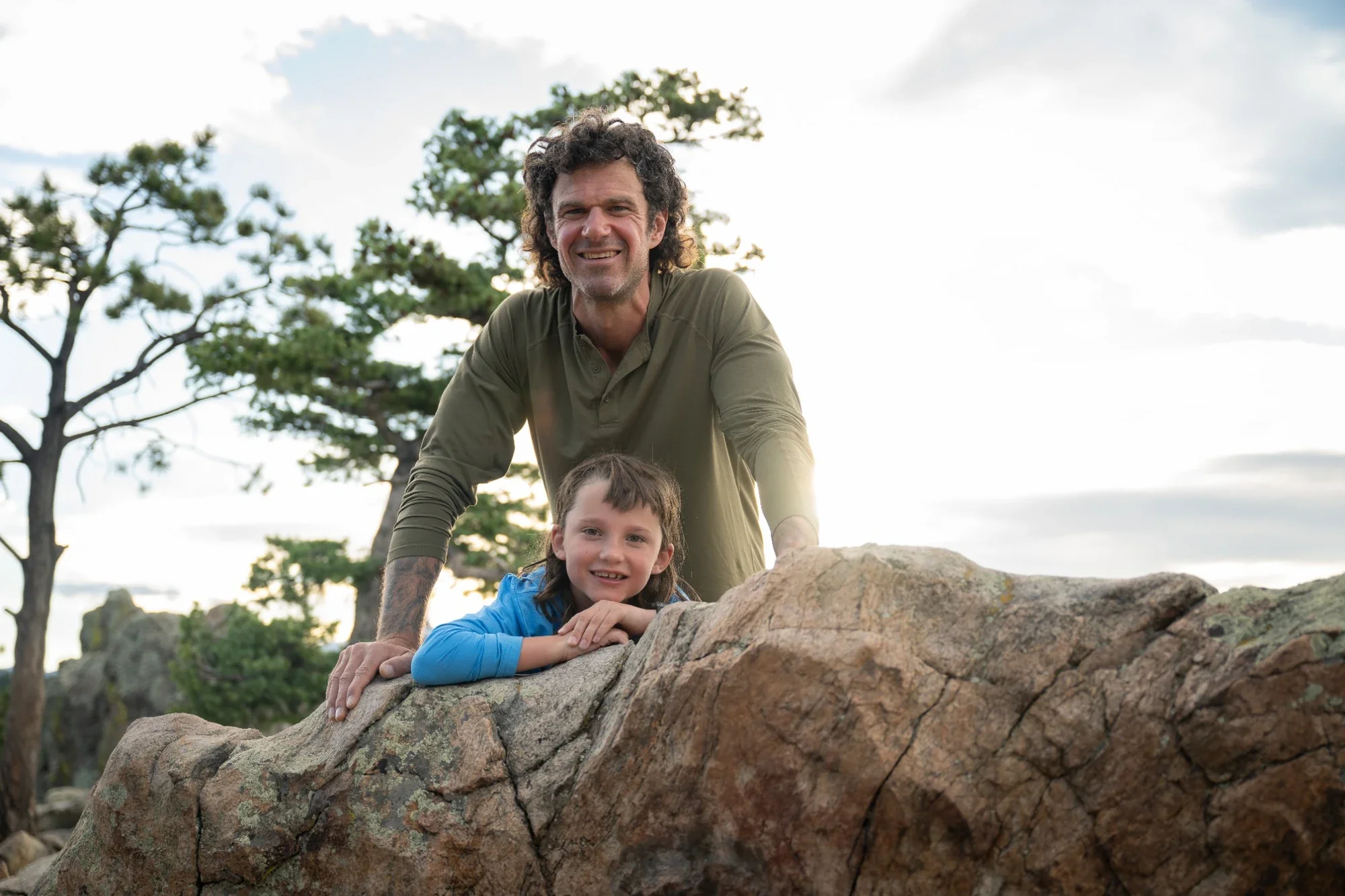 Father and son portrait on rock outcropping during a family photo session at Lost Gulch Overlook in Boulder, Colorado.